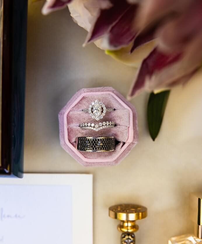 Wedding rings displayed in a blush velvet ring box