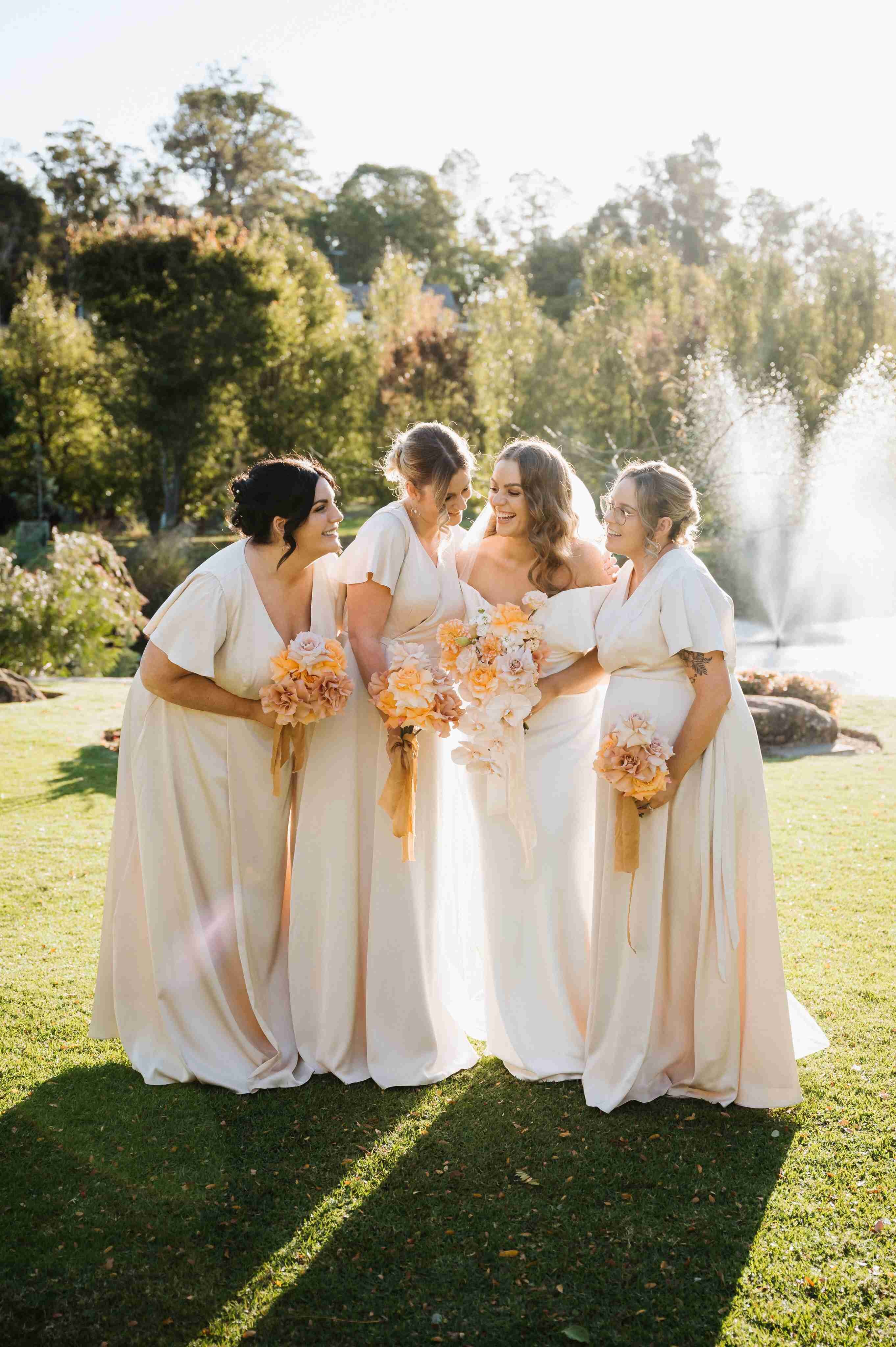Real Perth wedding, bridesmaids and bride laughing by a fountain