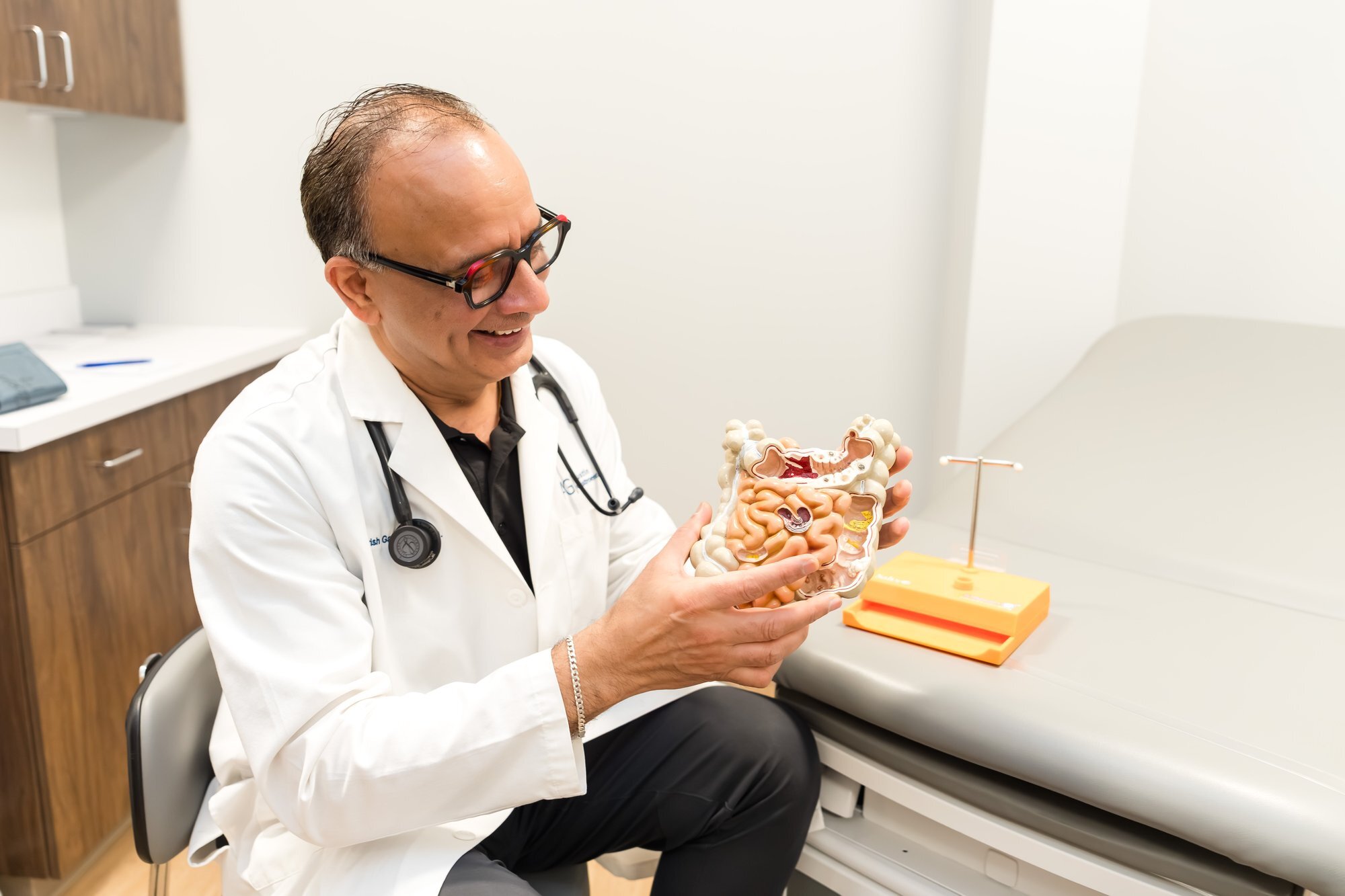 Commercial healthcare photography showing physician patient education moment, Austin Gastroenterology