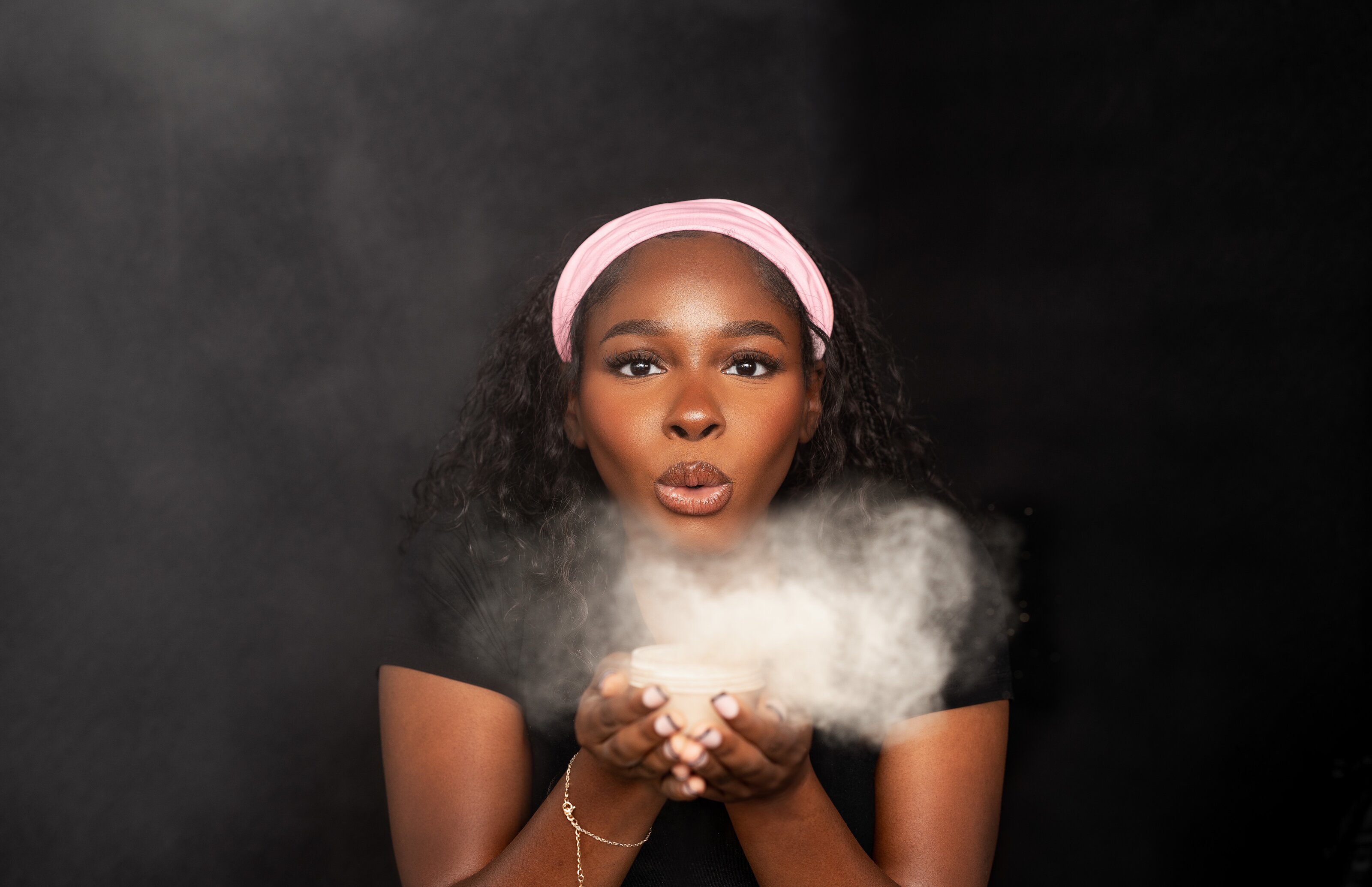 Lash artist blowing powder