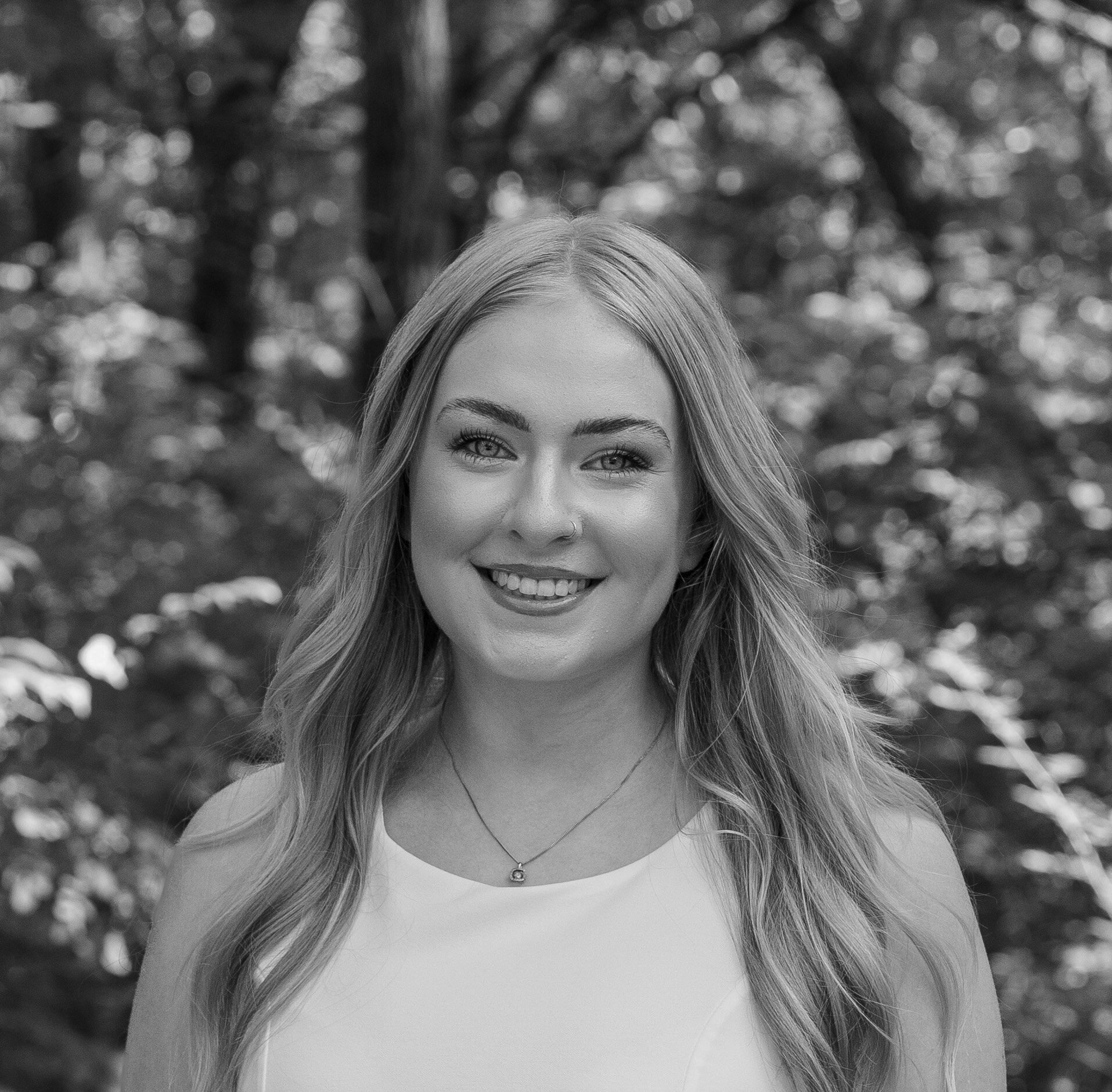 Black and white headshot, outdoors