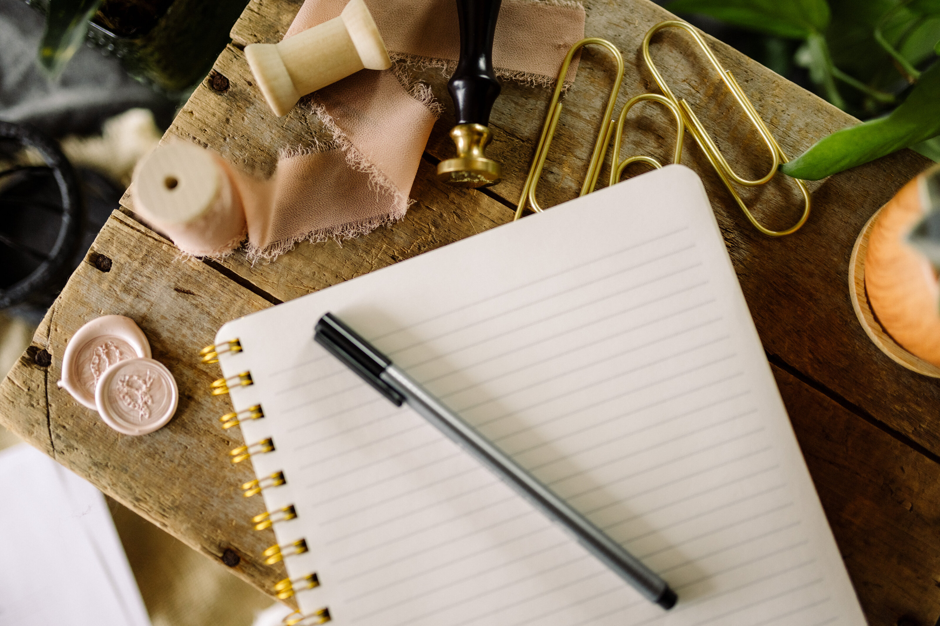Open notebook with a pen and ribbon