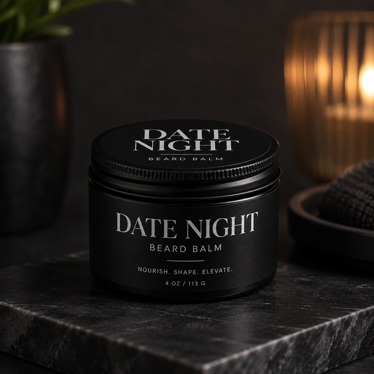 Date Night beard balm, black tin with wrap-around label on dark marble by candlelight