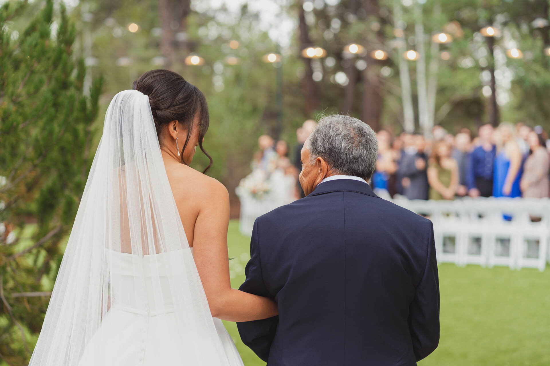 Heirloom wedding album from a Flagstaff elopement open on a wooden table with pine cones