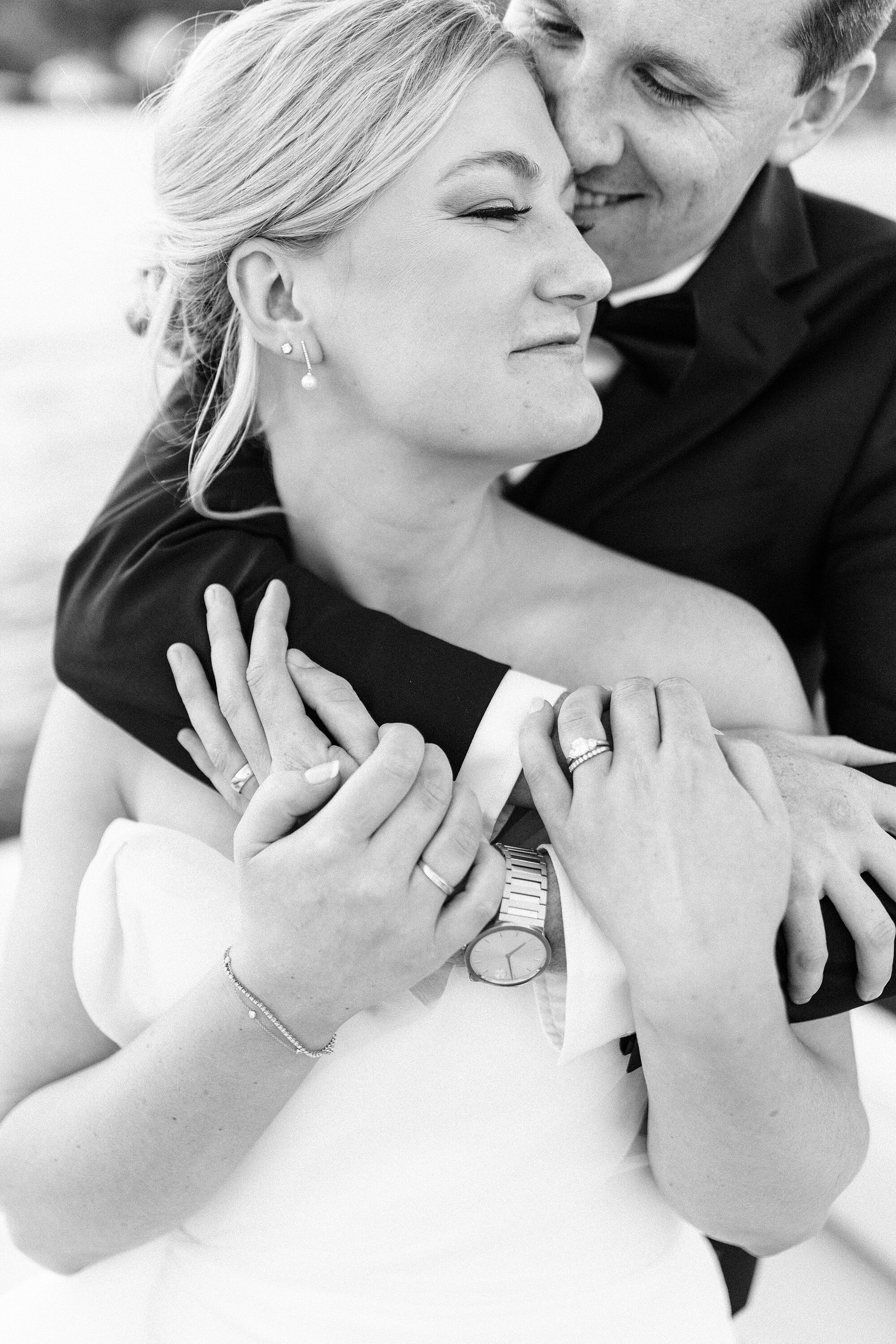 Black and white portrait of a couple embracing on their wedding day