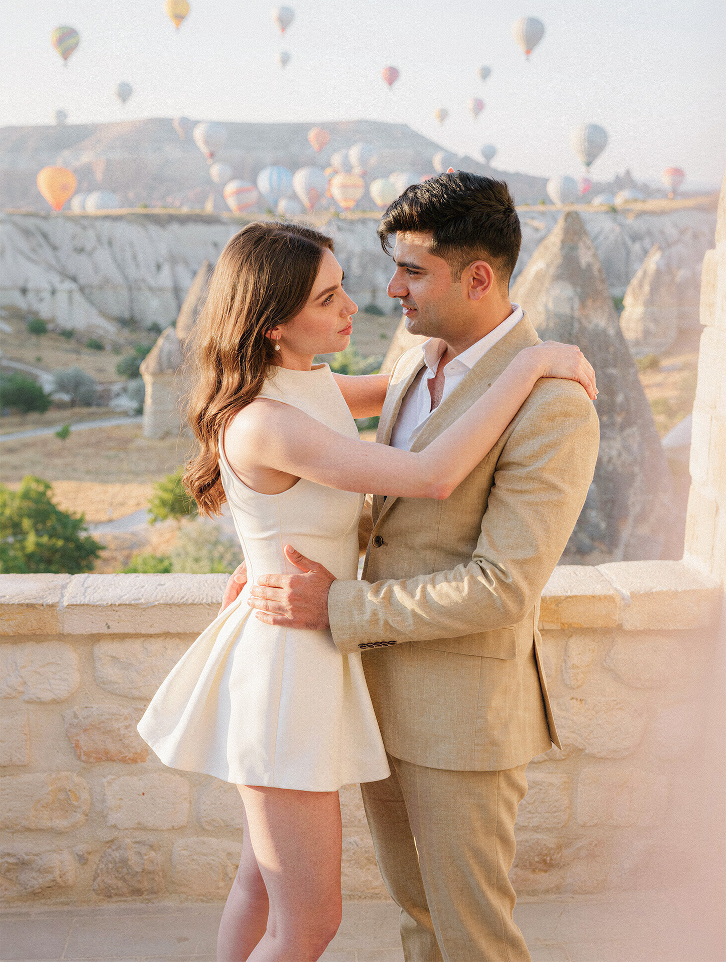 Bride and groom on a stone terrace in Cappadocia Turkey photographed by destination wedding photographer 4Karma Studio
