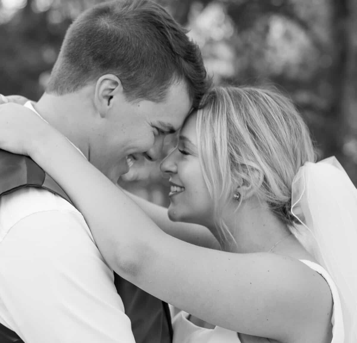Black and white photo of a couple touching foreheads during richmond va wedding historic tuckahoe