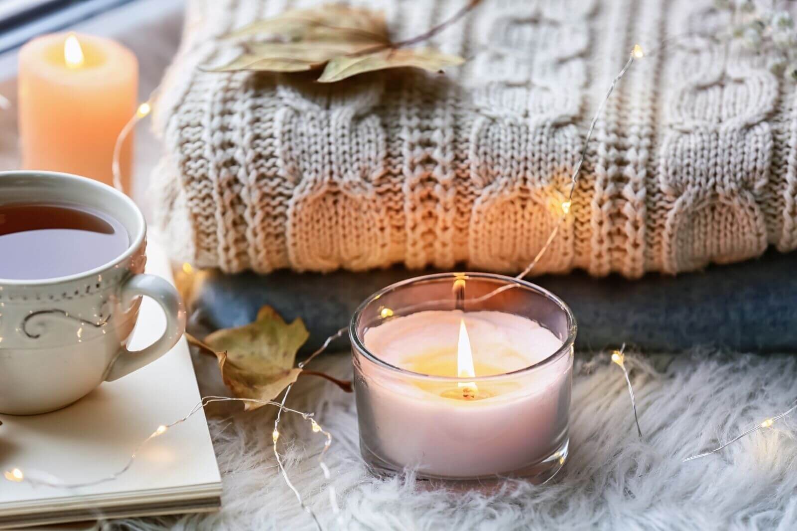 An open journal and a warm cup of tea on an autumn morning
