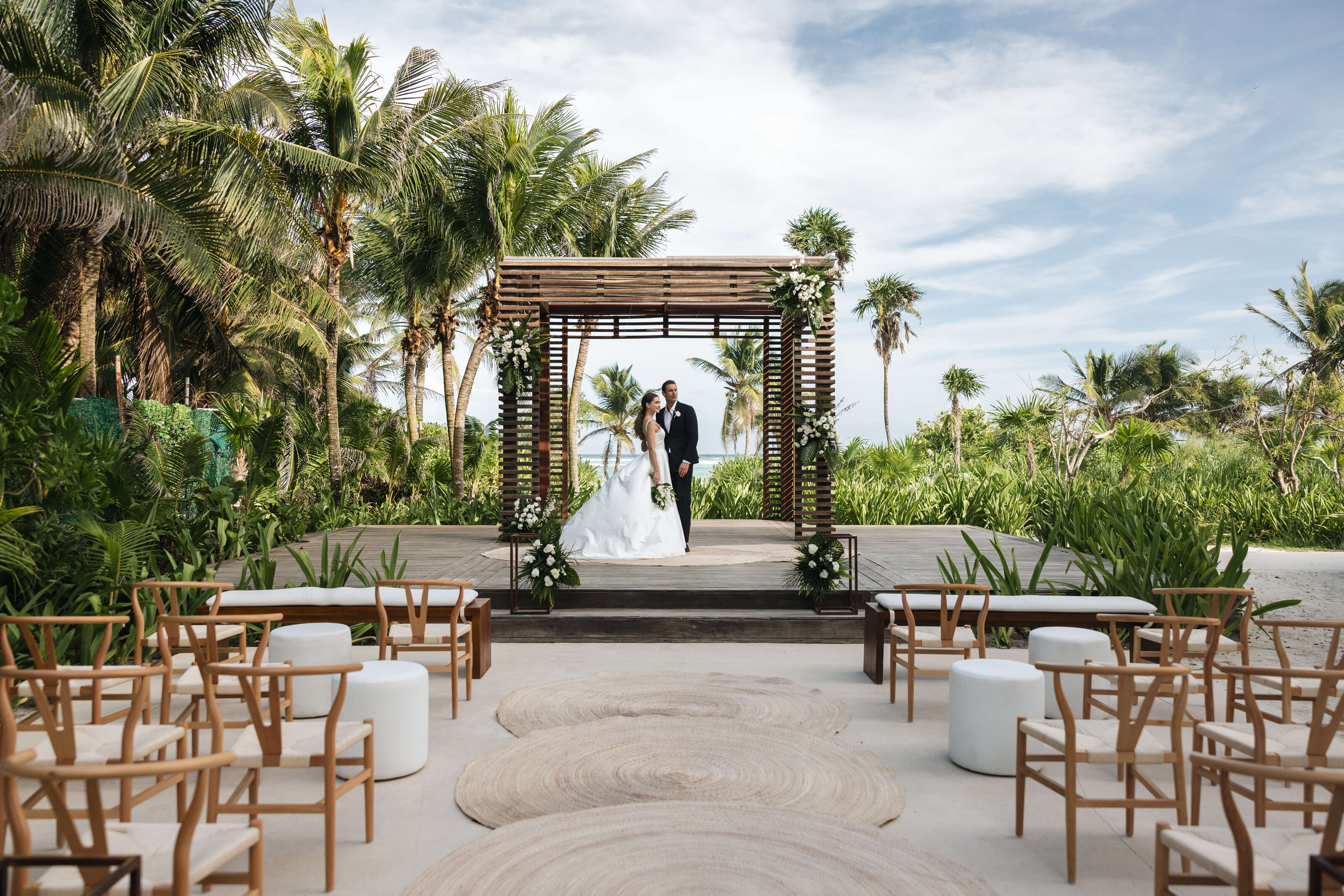 Bride and groom beneath a wedding gazebo at UNICO 20°87° in Riviera Maya