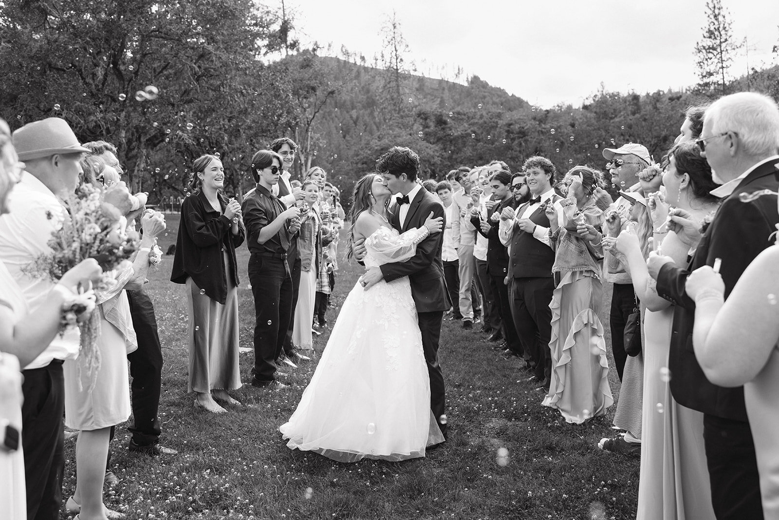 Bride and groom running through their cheering guests at the send-off