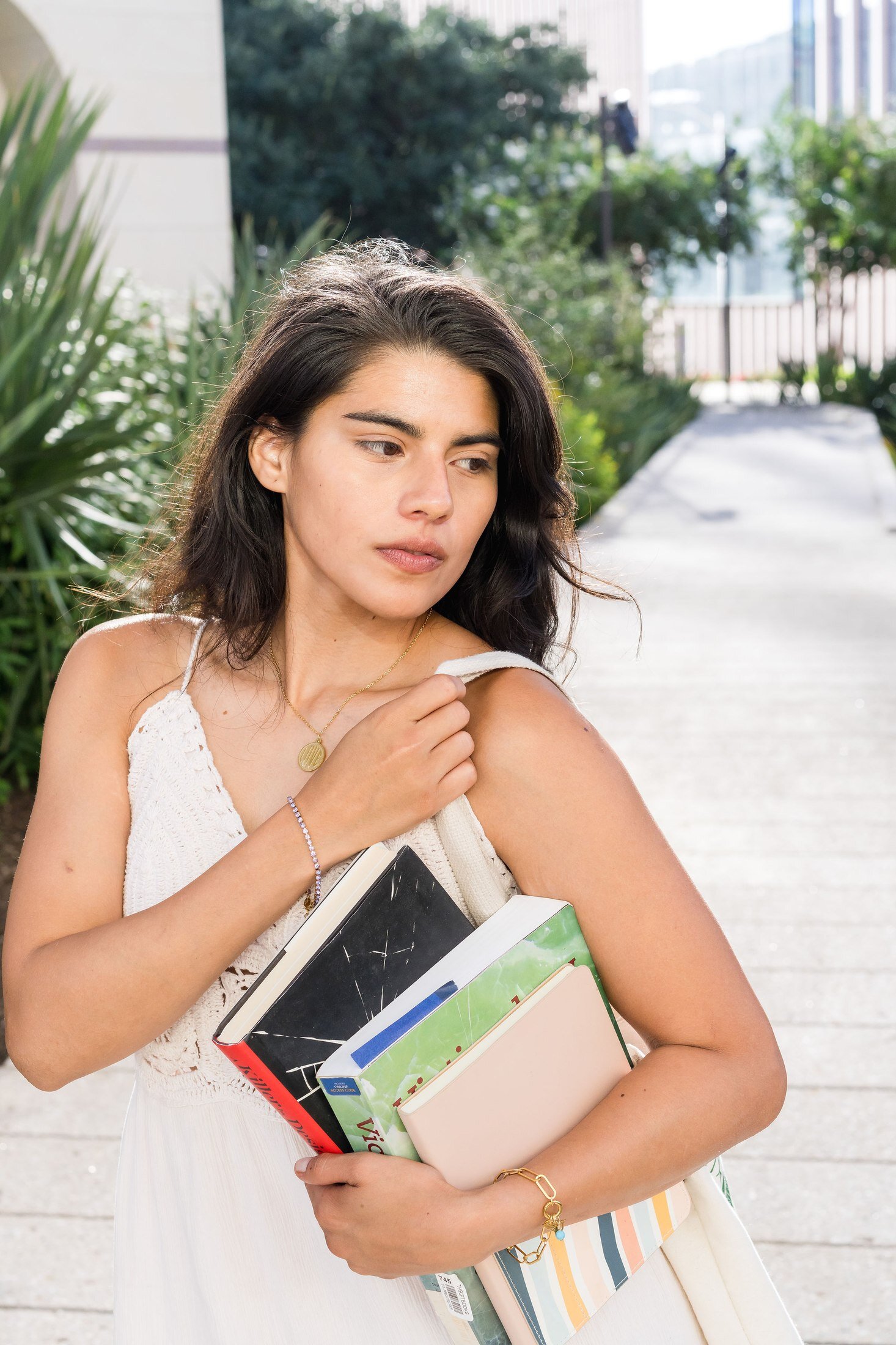 Charm Theory model carrying books on campus