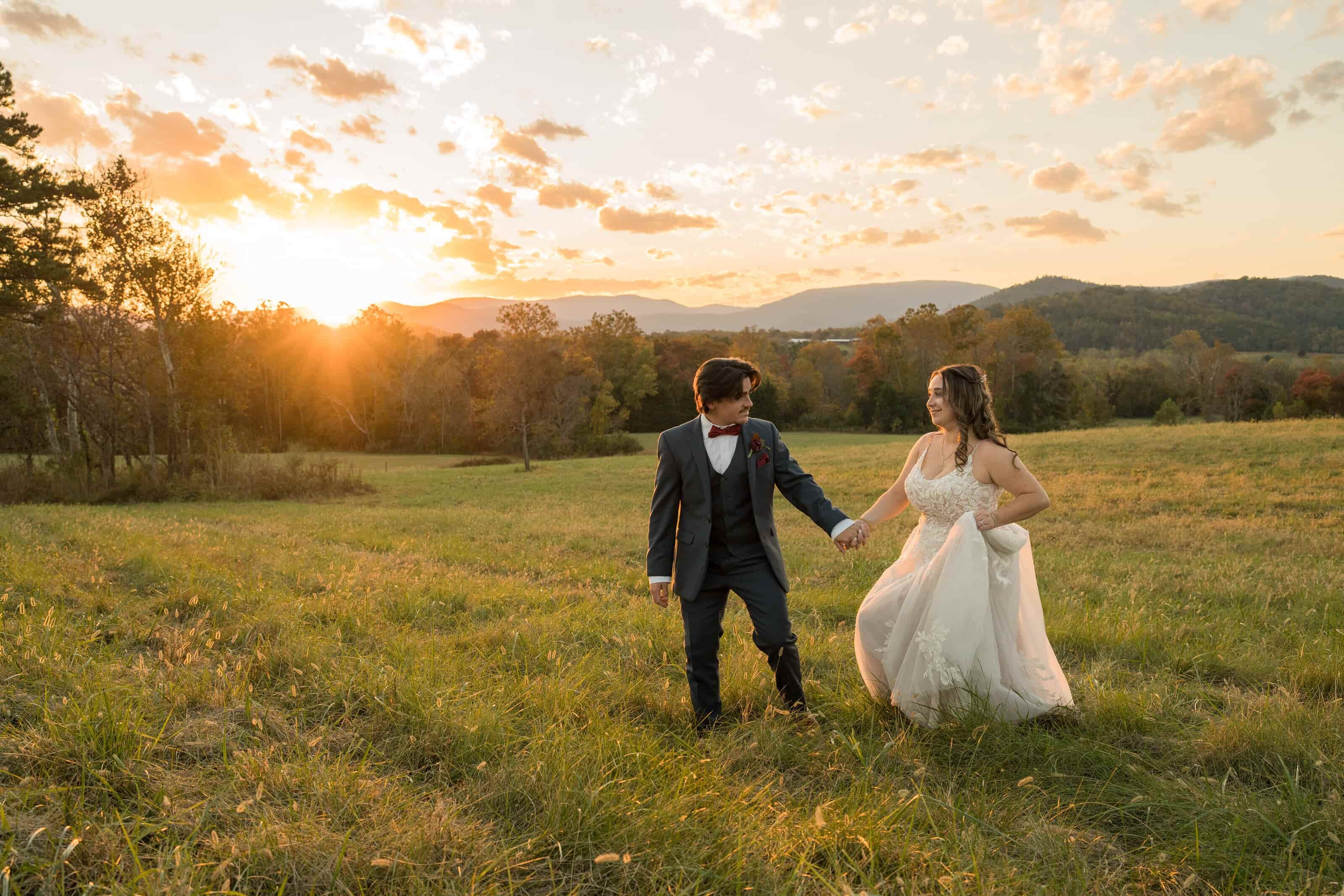Couple embracing in a field at sunset during an adventure elopement in the mountains