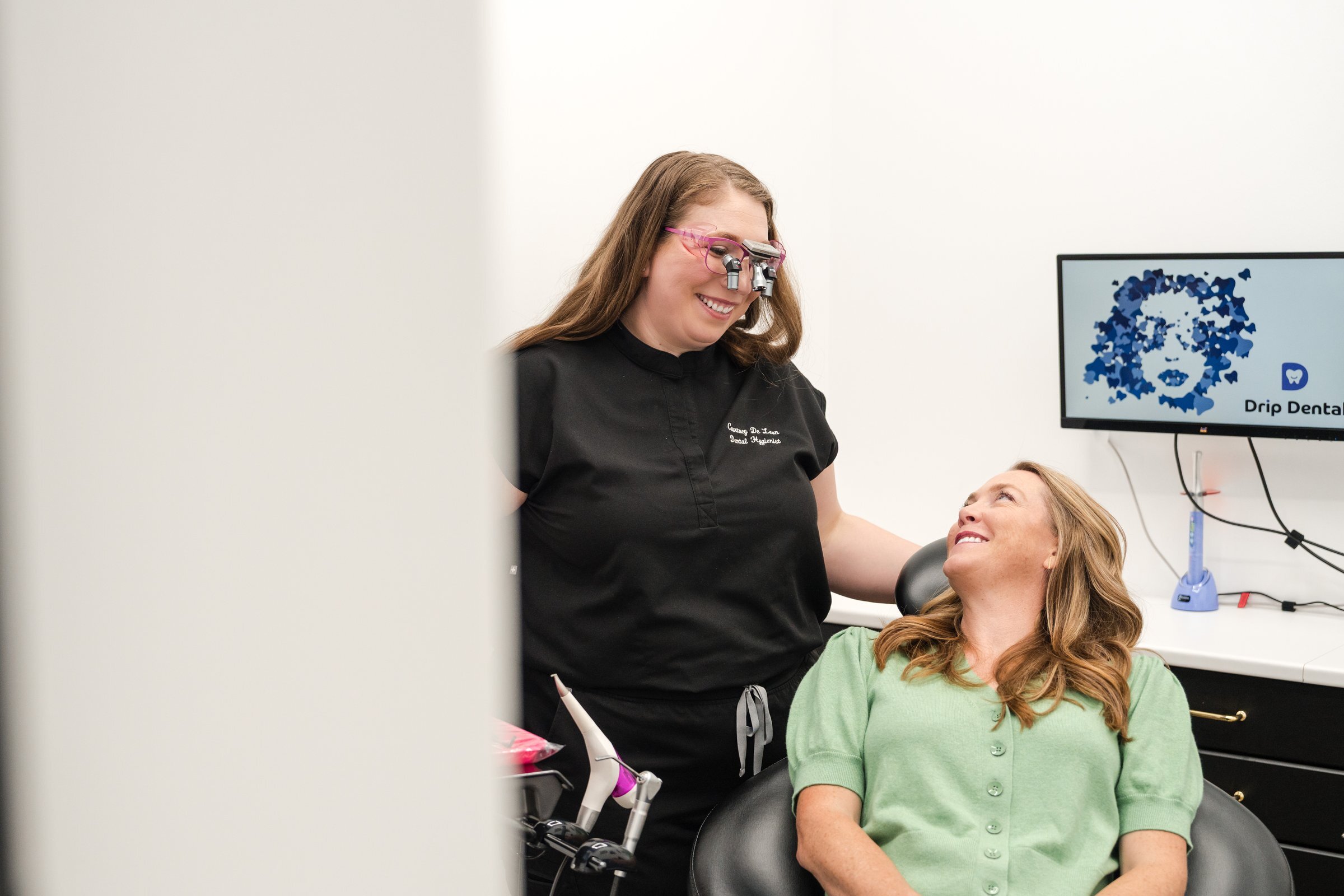 Drip Dental hygienist smiling with patient, Dripping Springs dental office