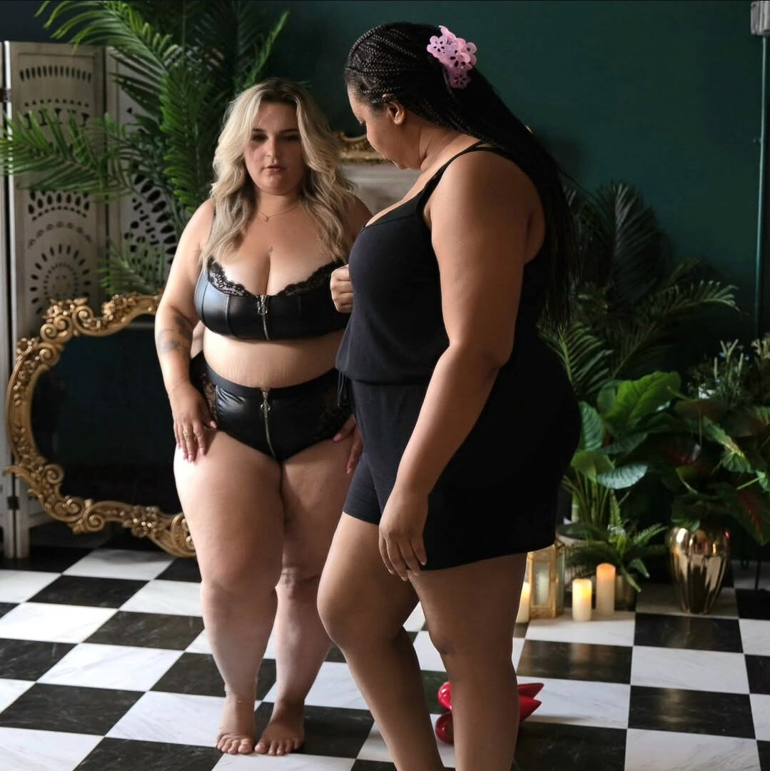 Behind the scene image of DC boudoir photographer Nicole Griffin taking a picture of a woman in black lingerie