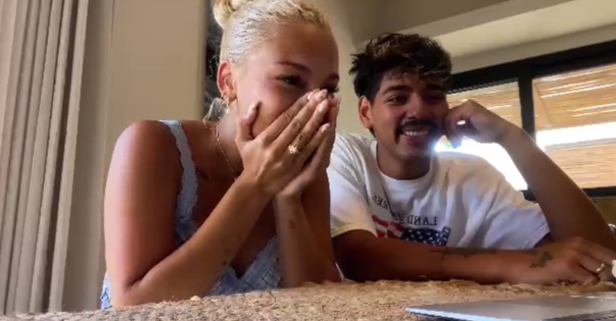Couple watching their wedding film together for the first time