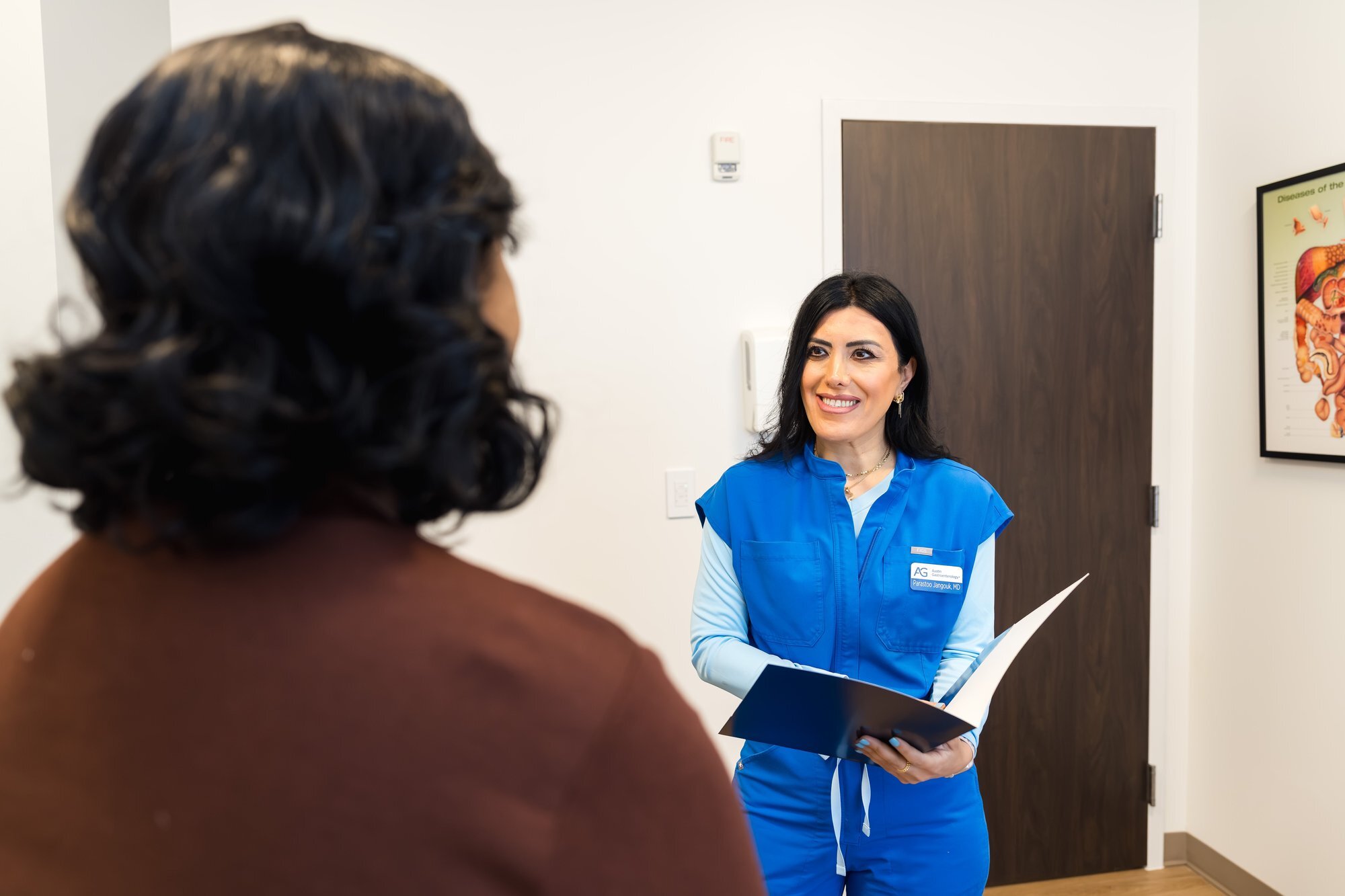 Austin Gastroenterology physician greeting patient in exam room