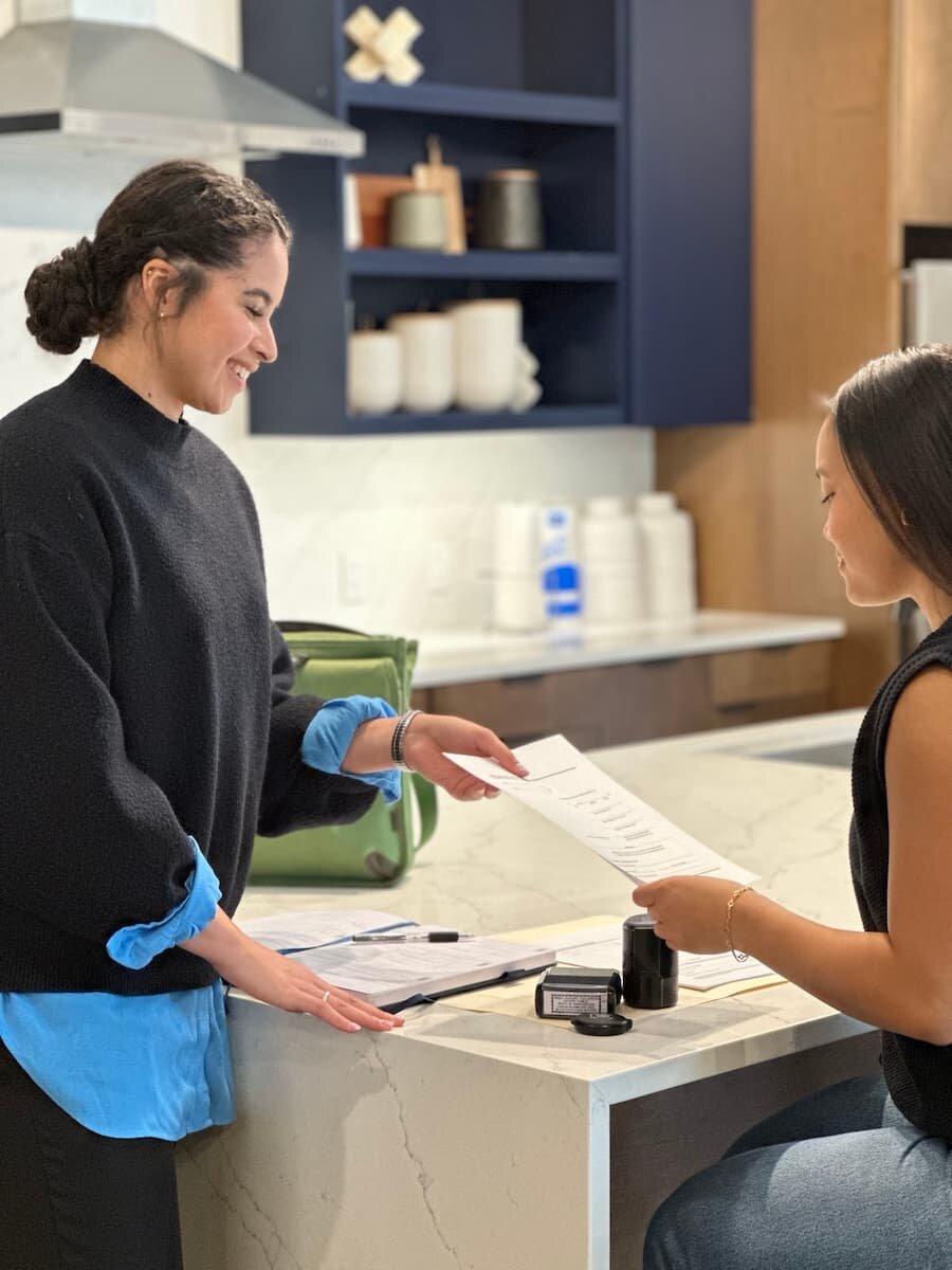 Ingrid Santos helping a client with mobile notary documents in Austin Texas