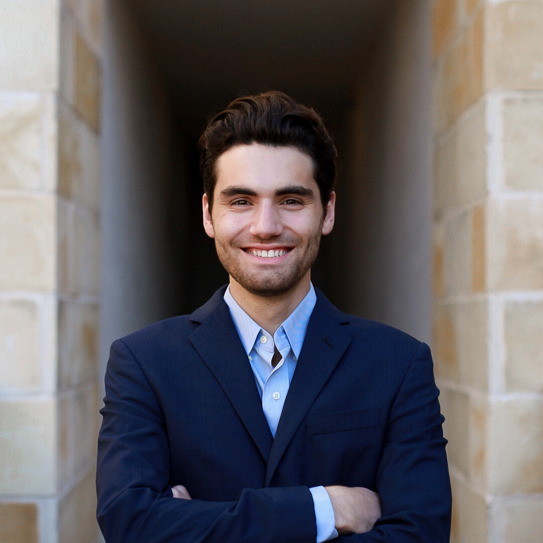 Confident headshot in a navy suit