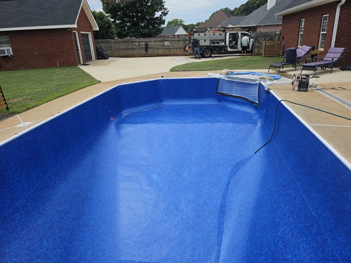 Inground pool renovation near Warner Robins GA — completed spa and pavilion with new blue waterline tile by Mid State Pools