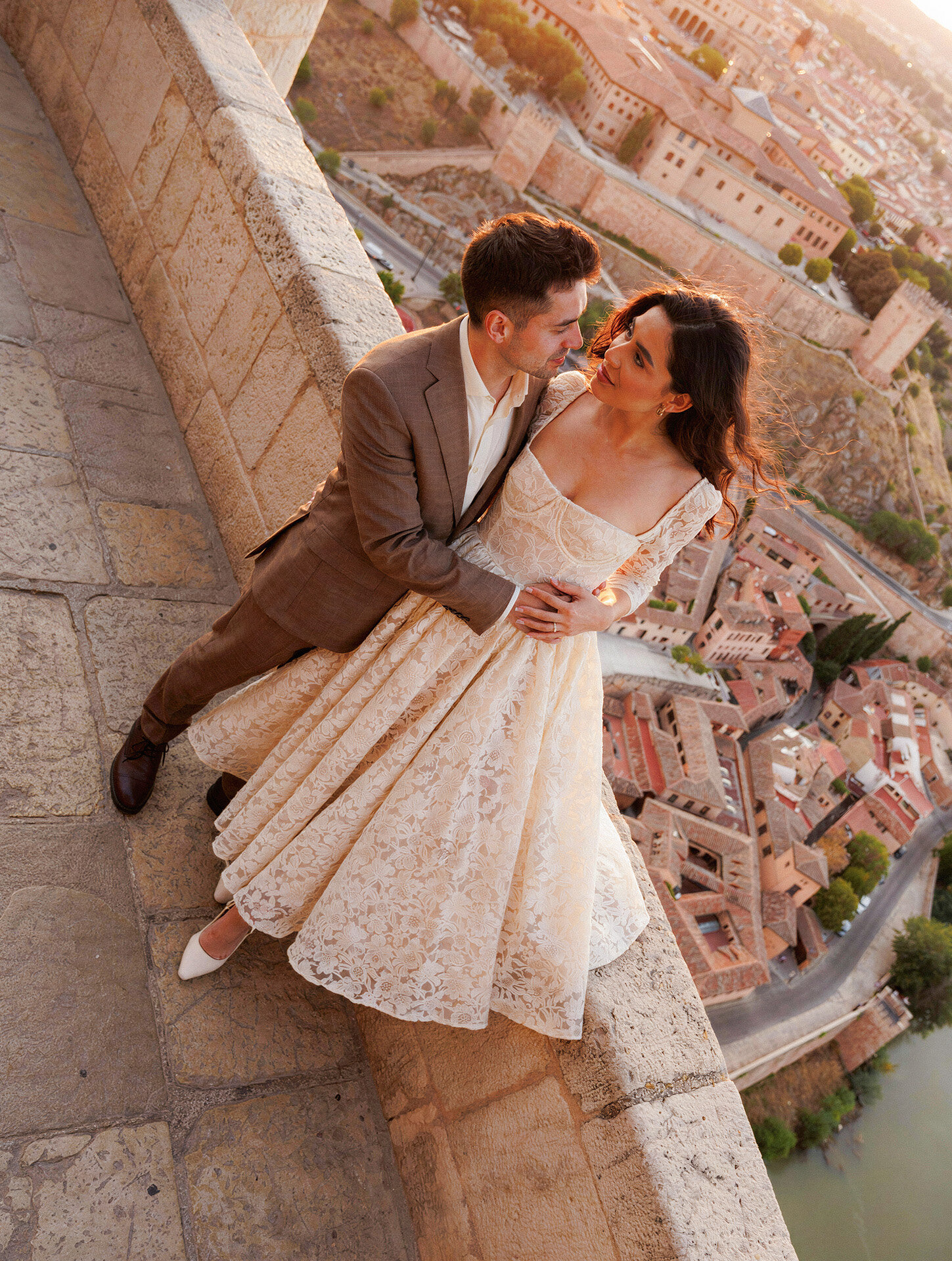 Romantic bride and groom portrait surrounded by medieval stone architecture in Toledo, Spain