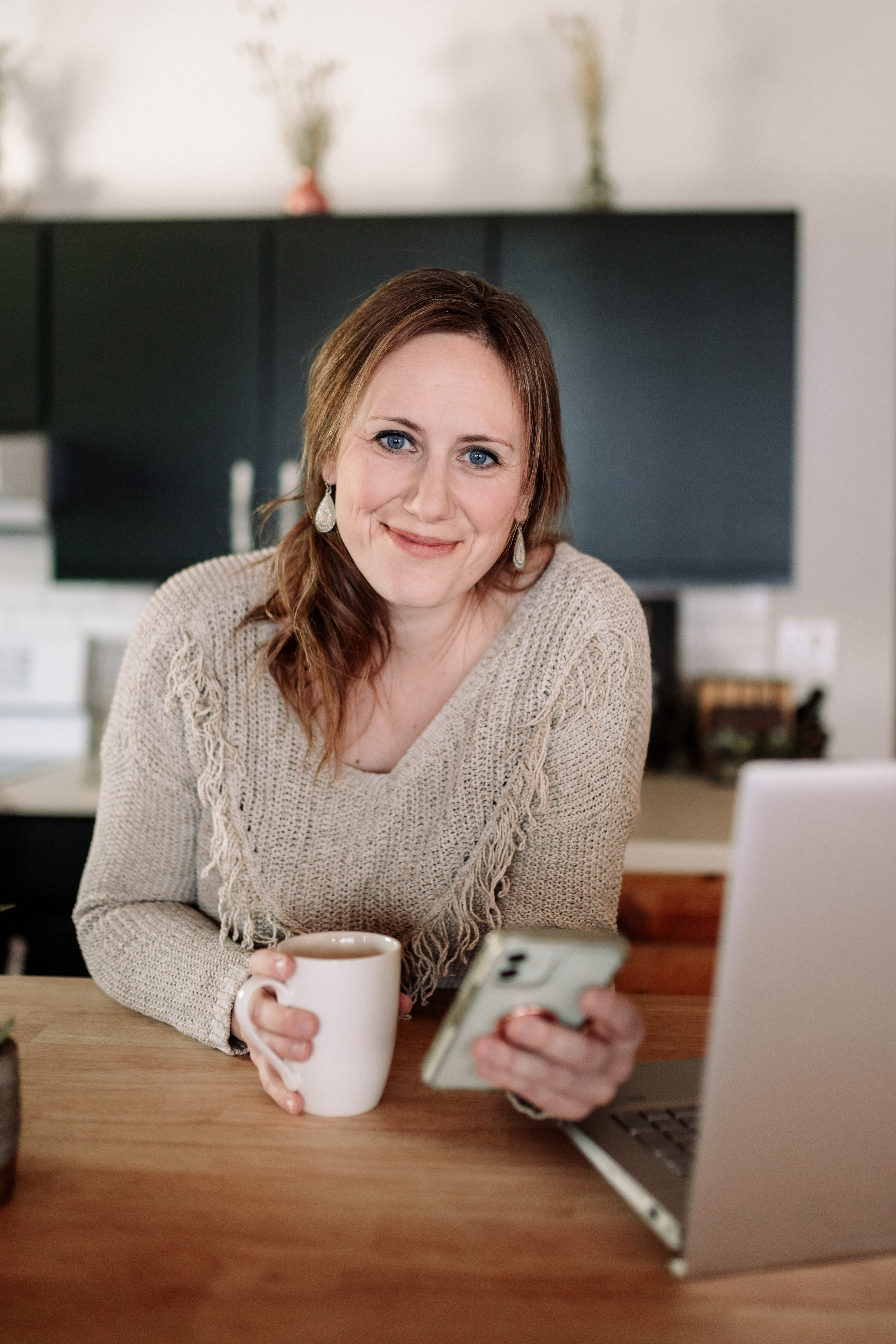 Emily McNiel working on a laptop at her kitchen table