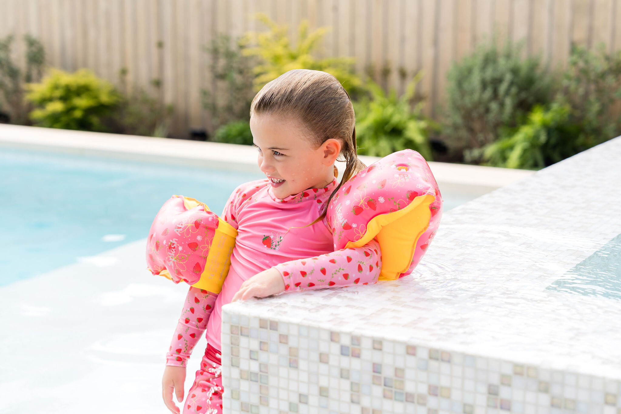 Girl wearing strawberry print swim armbands for Splash About
