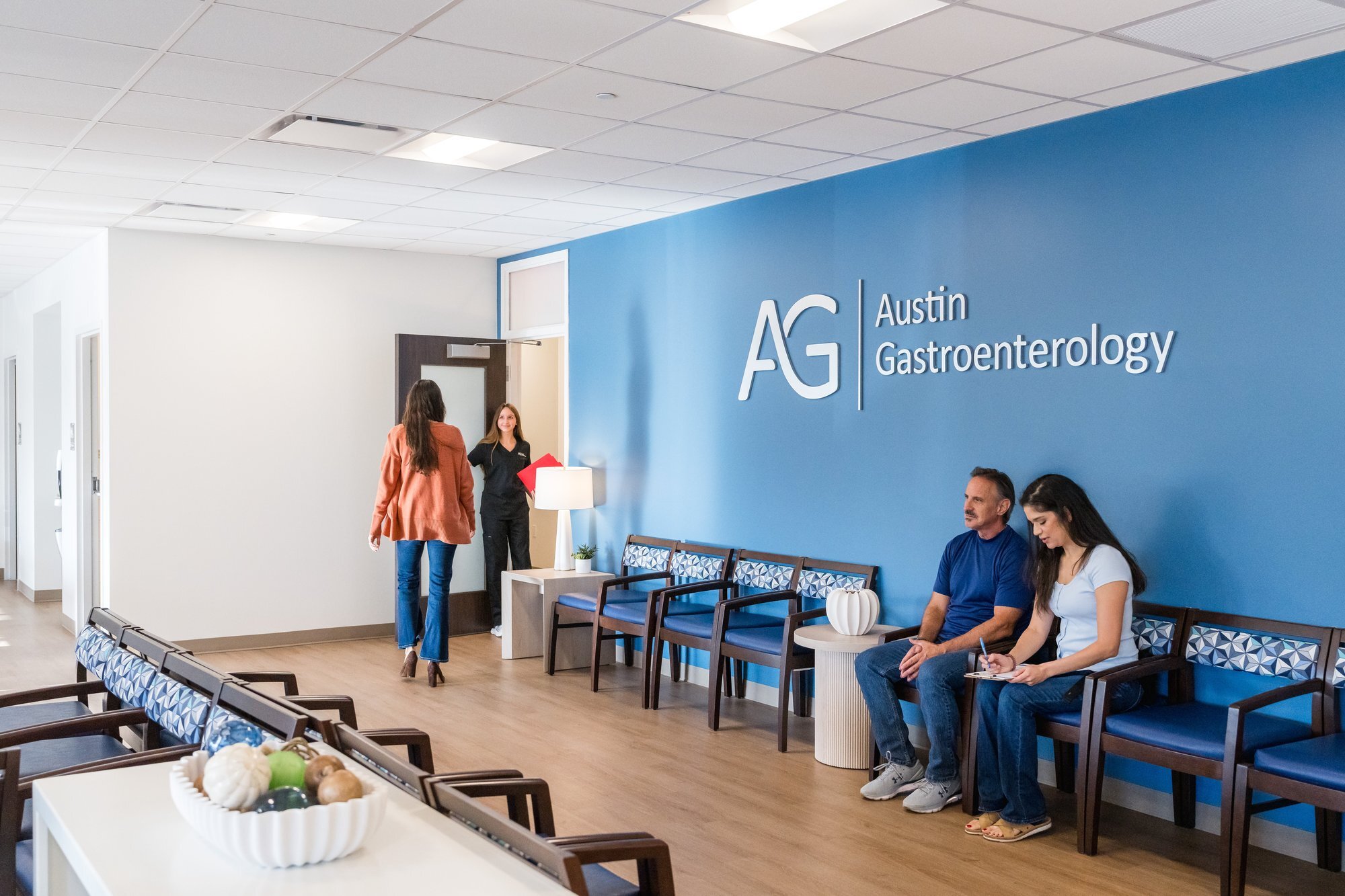 Austin Gastroenterology patient check-in at clinic front desk, healthcare photography Austin