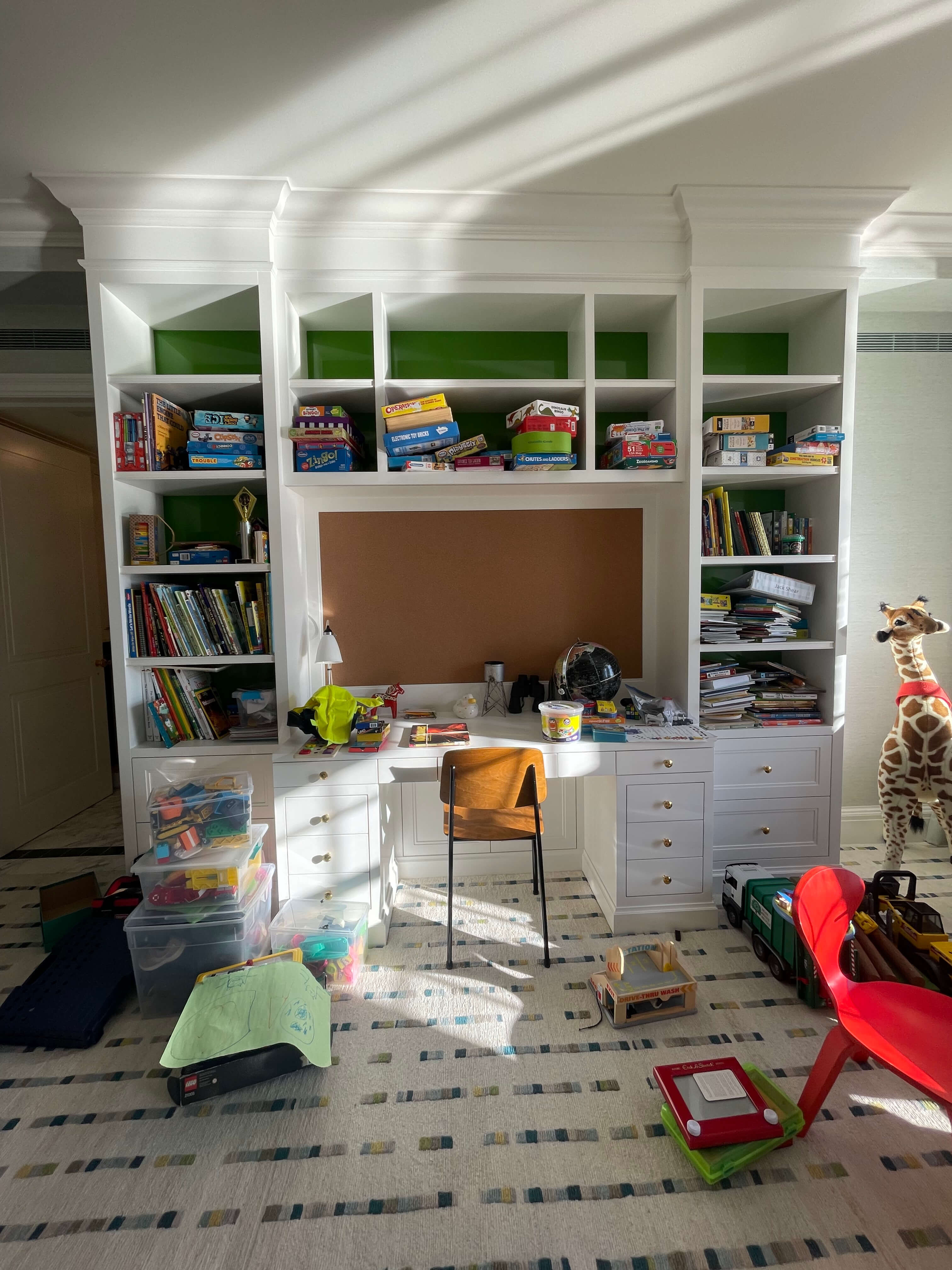 Kids' room with built-in shelving and storage before organization.