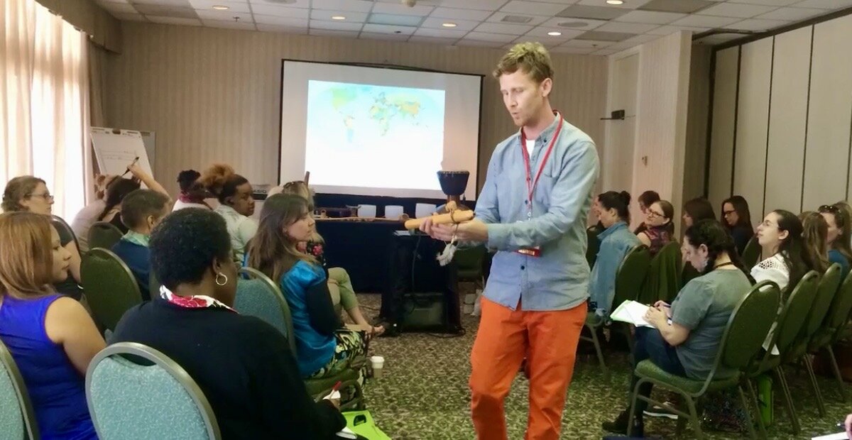 Daniel demonstrating an instrument among adult workshop participants
