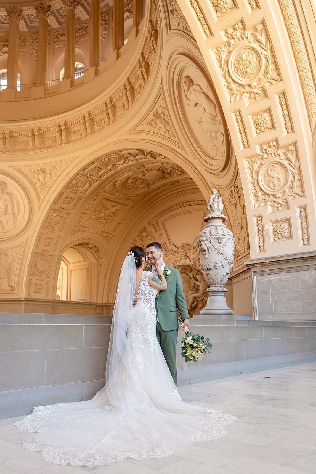 Rachel and Josh sharing a moment beneath the arch at SF City Hall