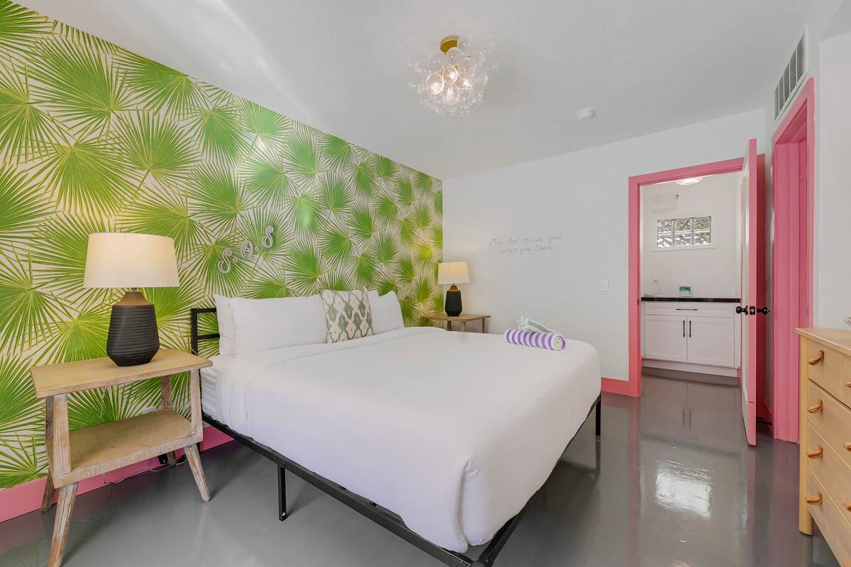 Bright bedroom with palm wallpaper