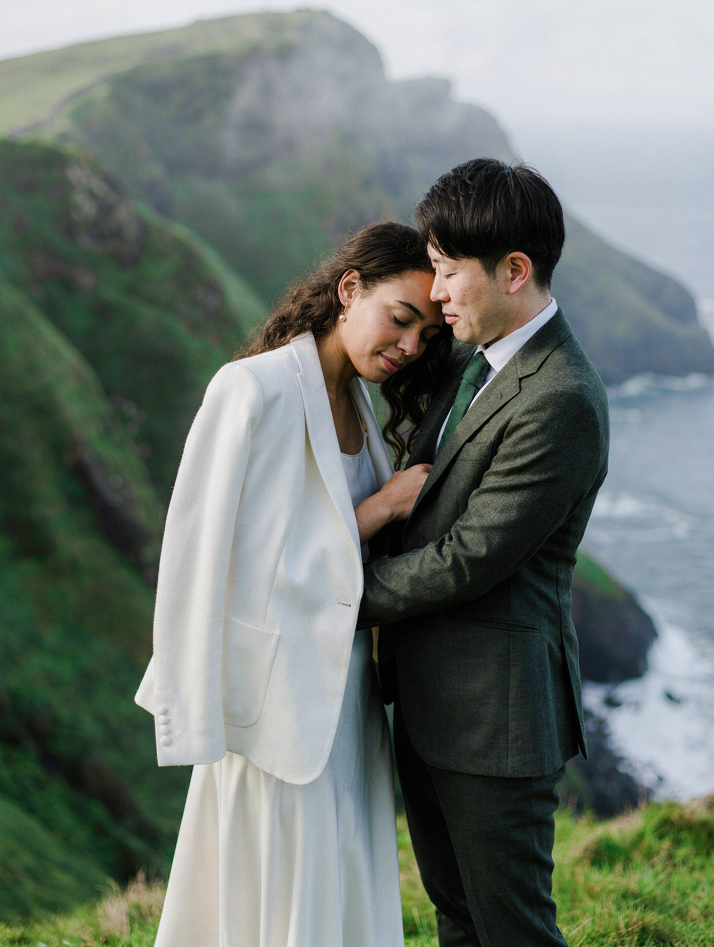 Bride and groom sharing an intimate moment on the dramatic Atlantic coast of Northern Spain