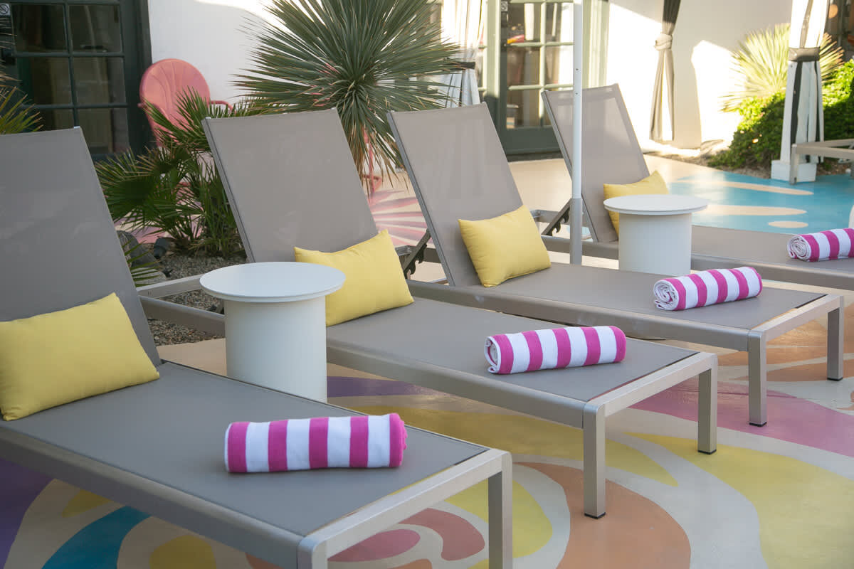 Poolside loungers with rolled towels