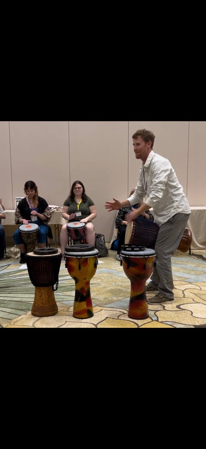 Daniel facilitating a group drumming experience