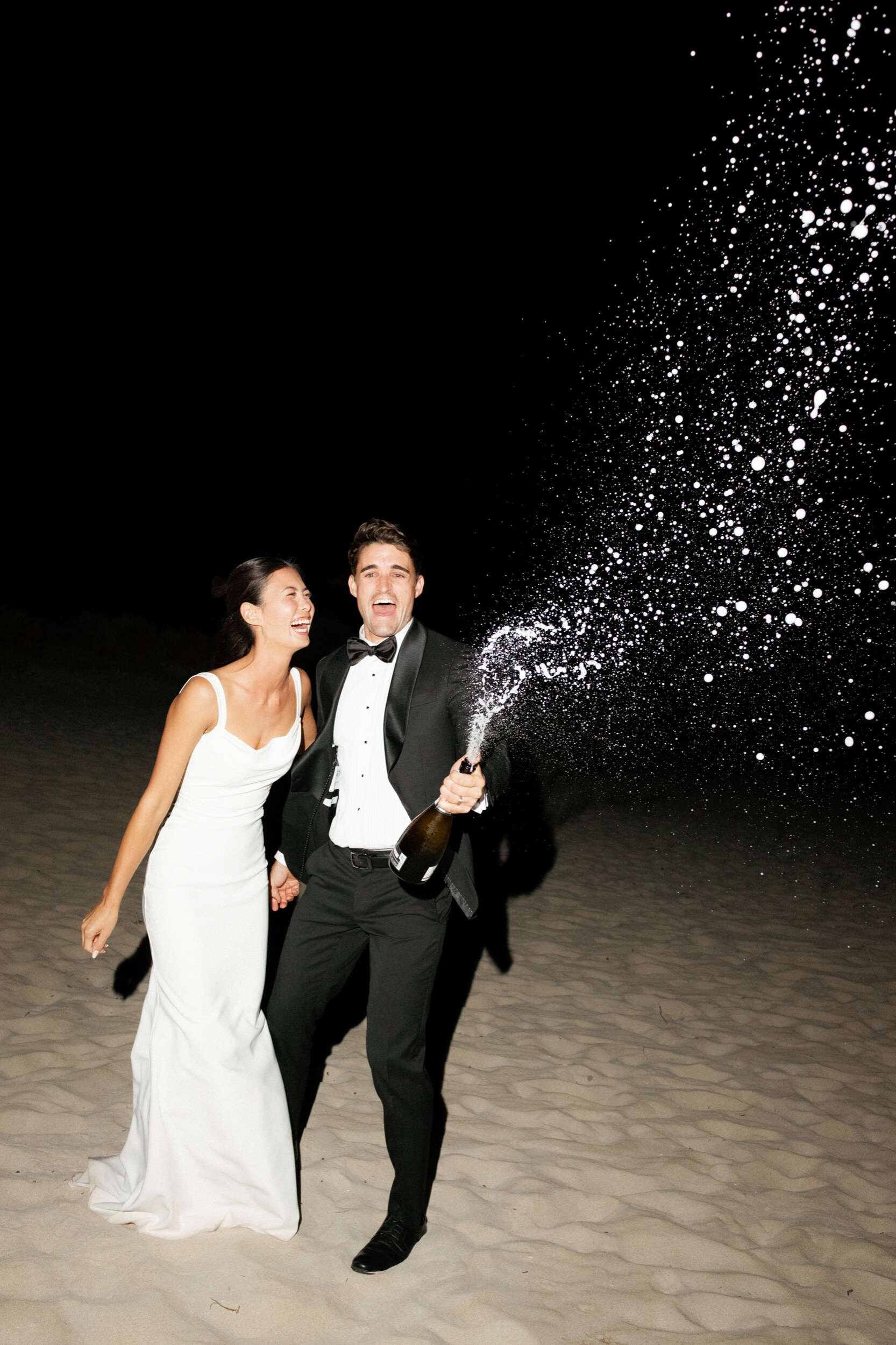 Real Perth wedding at Bunker Bay, champagne pop on the beach at night