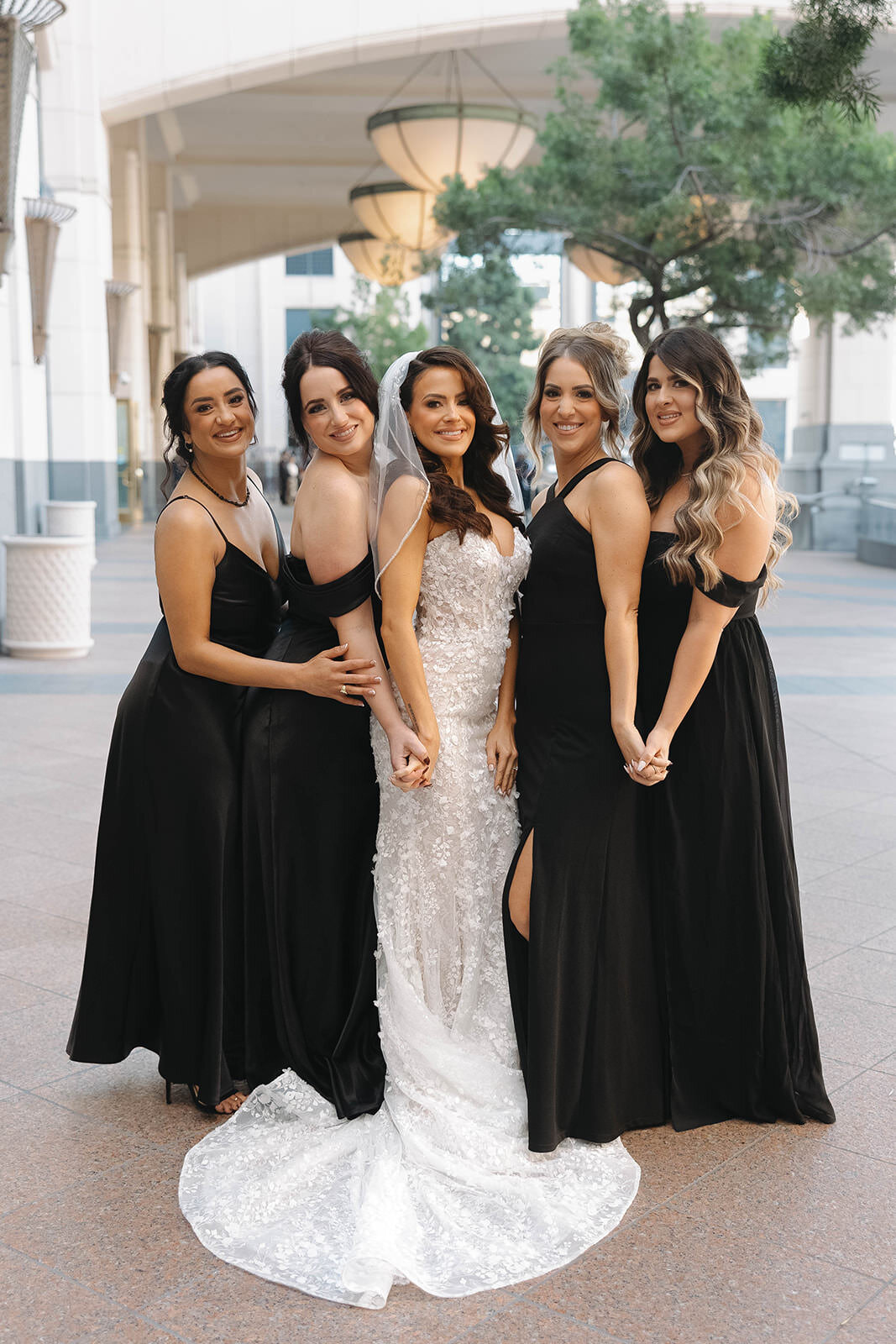 Bride with her bridesmaids in black