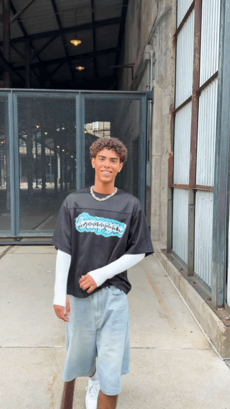 video of edgy boy laughing during his urban senior pictures in minneapolis