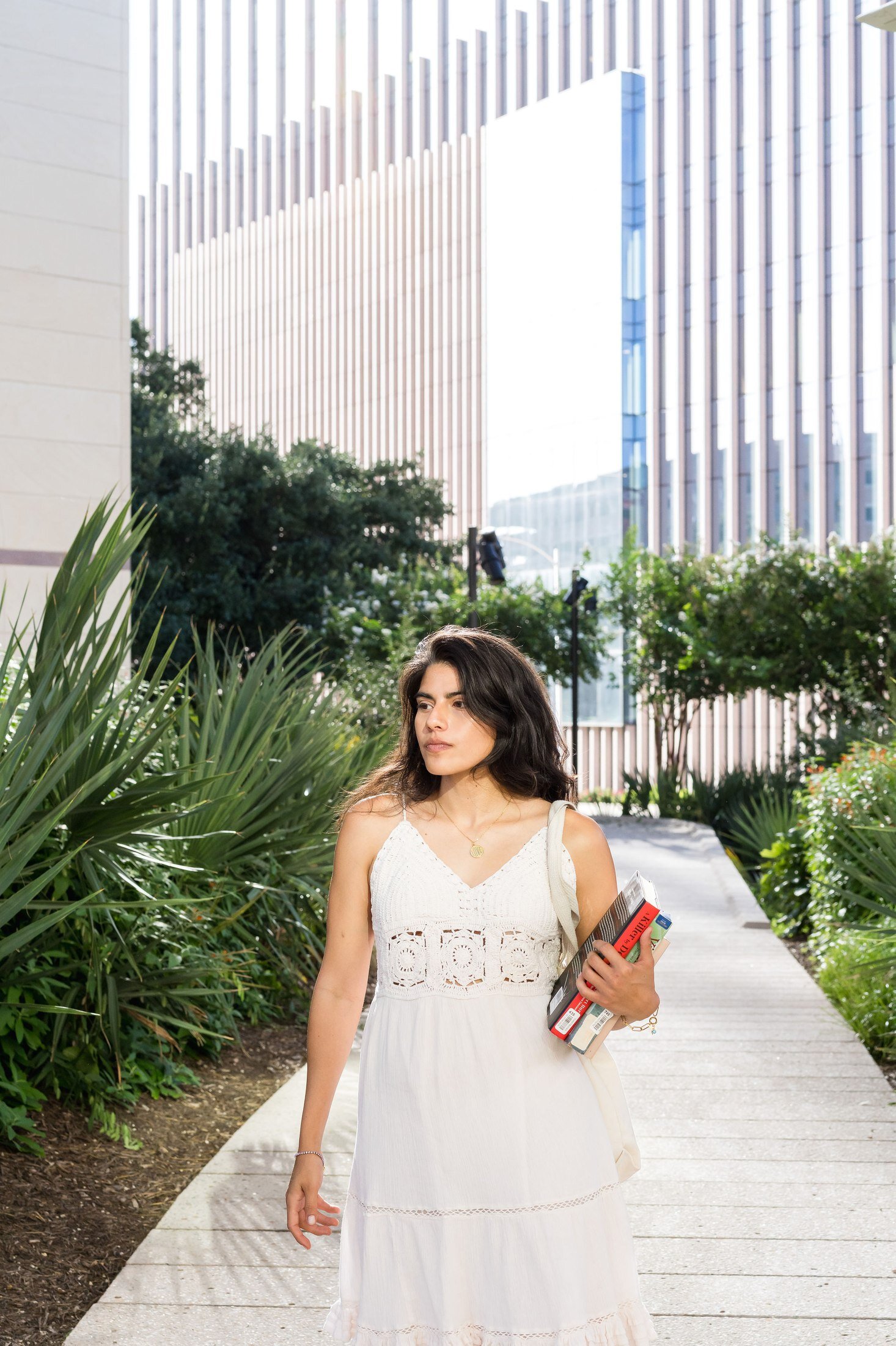 Charm Theory model walking on campus wearing charm necklace