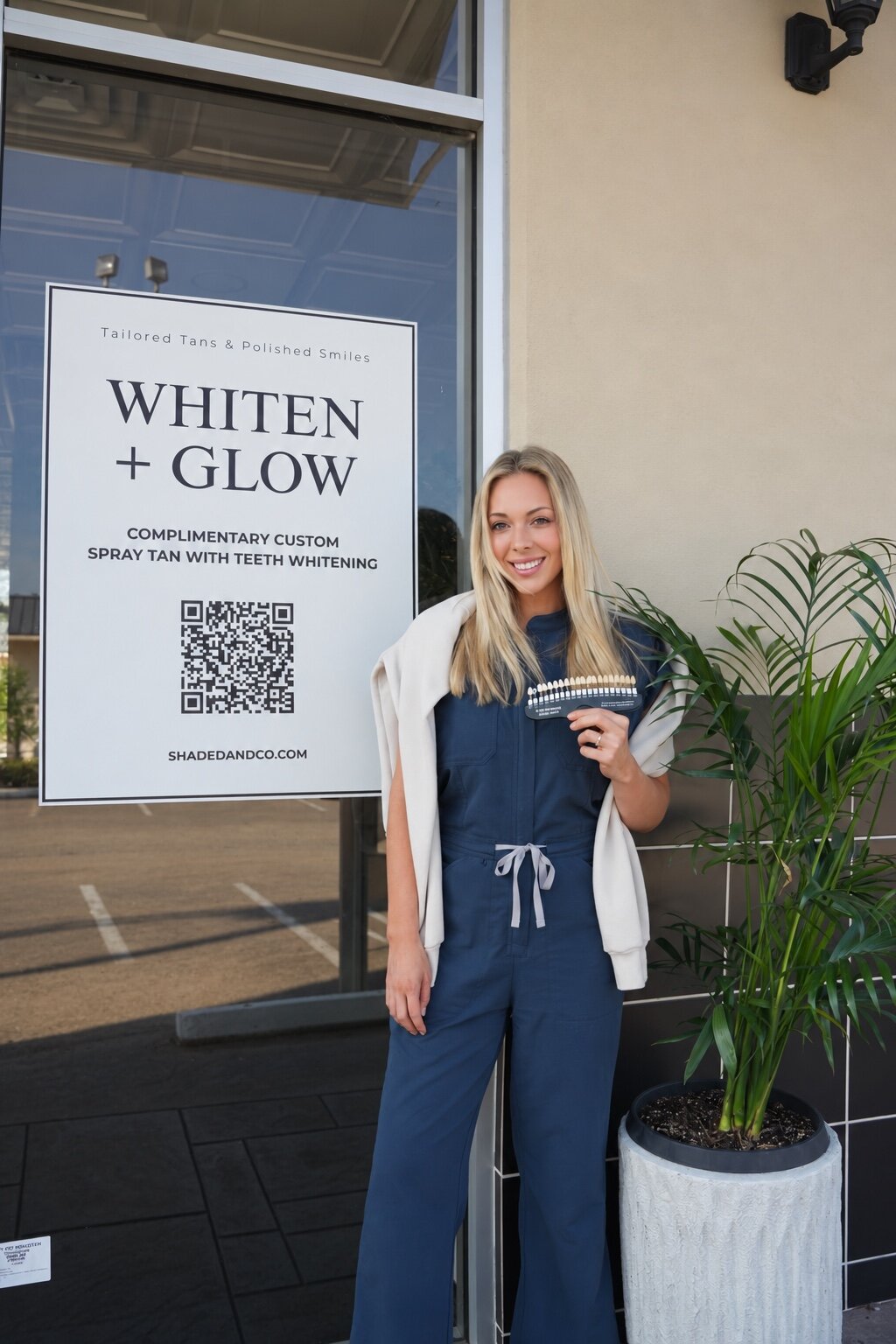 Logann Hatcher outside Shaded and Co in Houston beside the Whiten and Glow sign