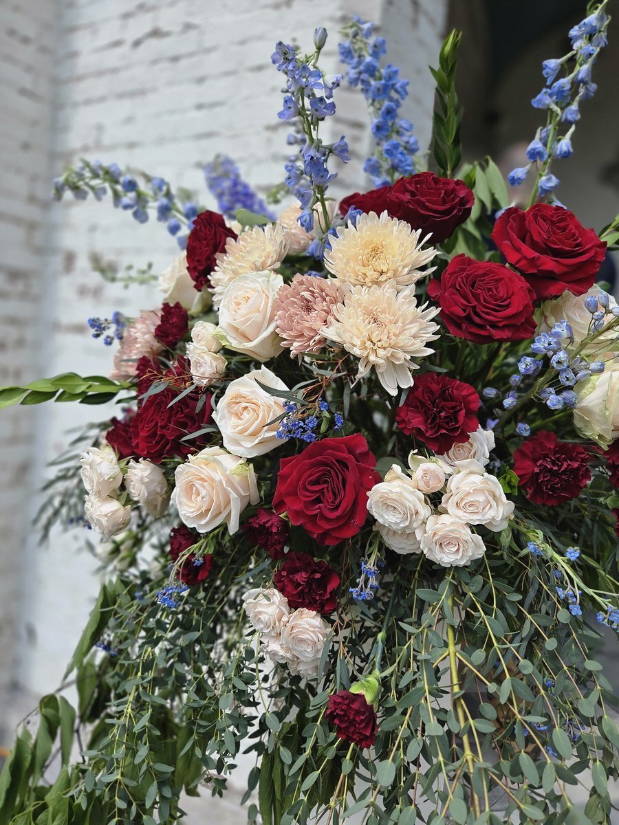 Burgundy, blush, cream, and blue wedding floral installation.