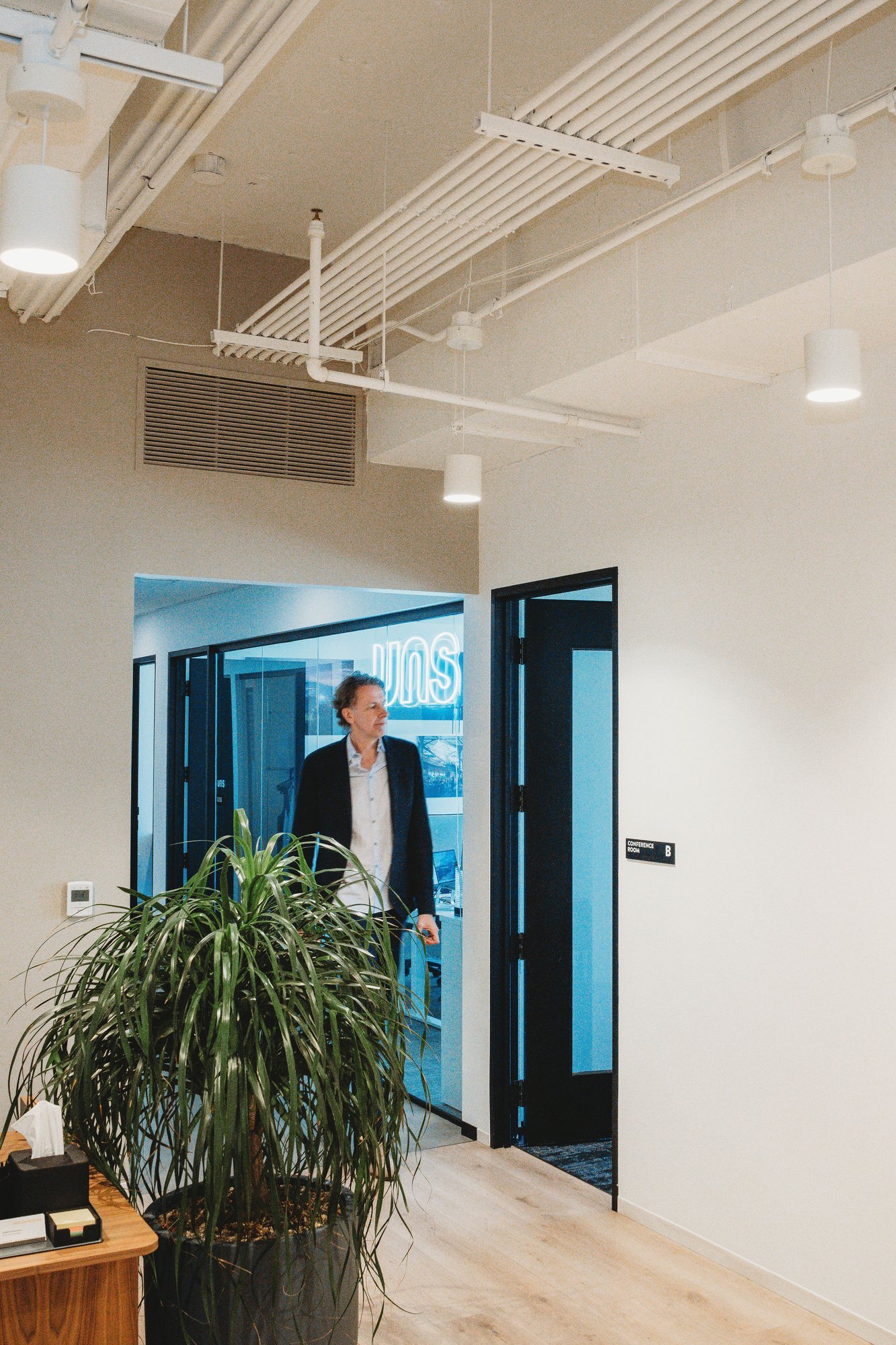 UNS office entrance with neon sign, Austin corporate photography