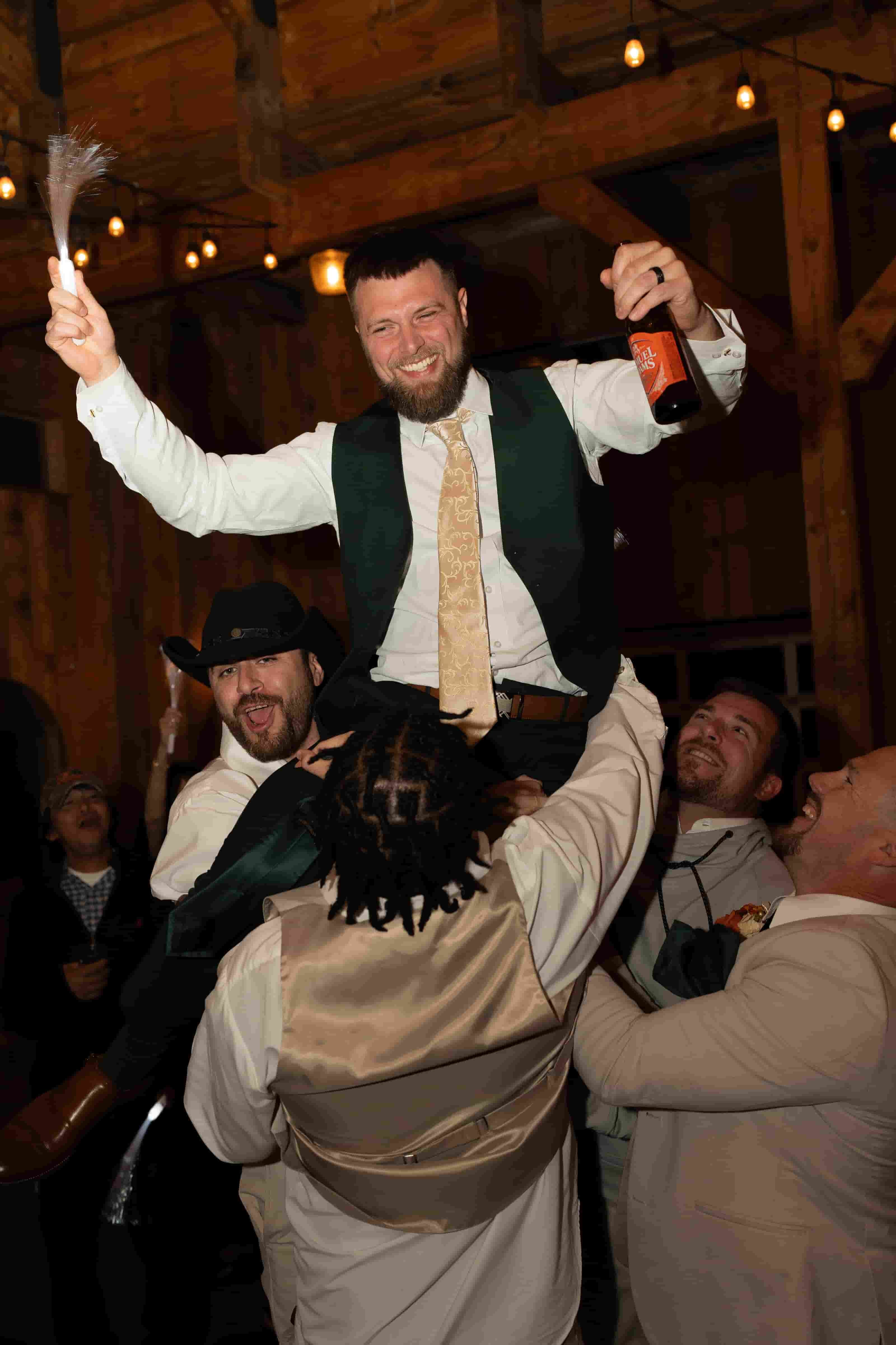 Groom lifted onto his friends' shoulders at a wedding in Charlottesville, Virginia
