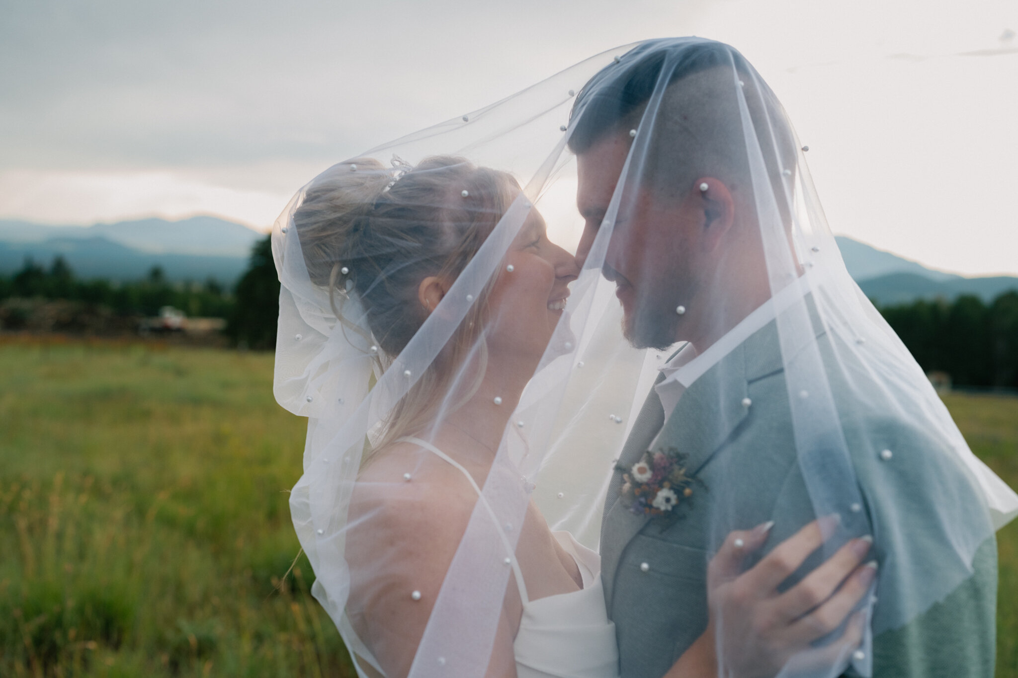 Couple eloping in Flagstaff Arizona surrounded by Ponderosa pines during golden hour