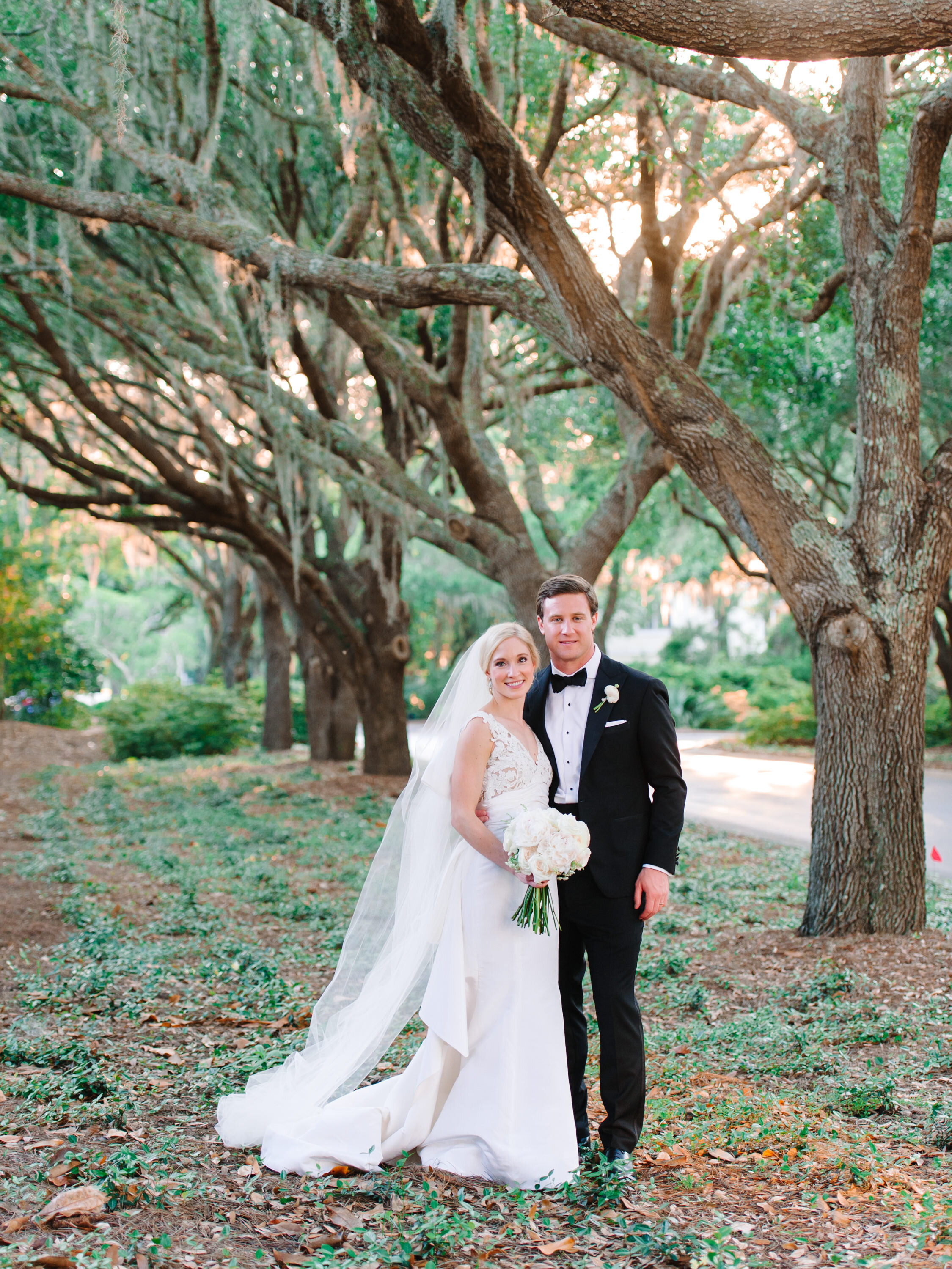 Bride and groom wedding portrait beneath oak trees at DeBordieu Colony Club near Pawleys Island, SC