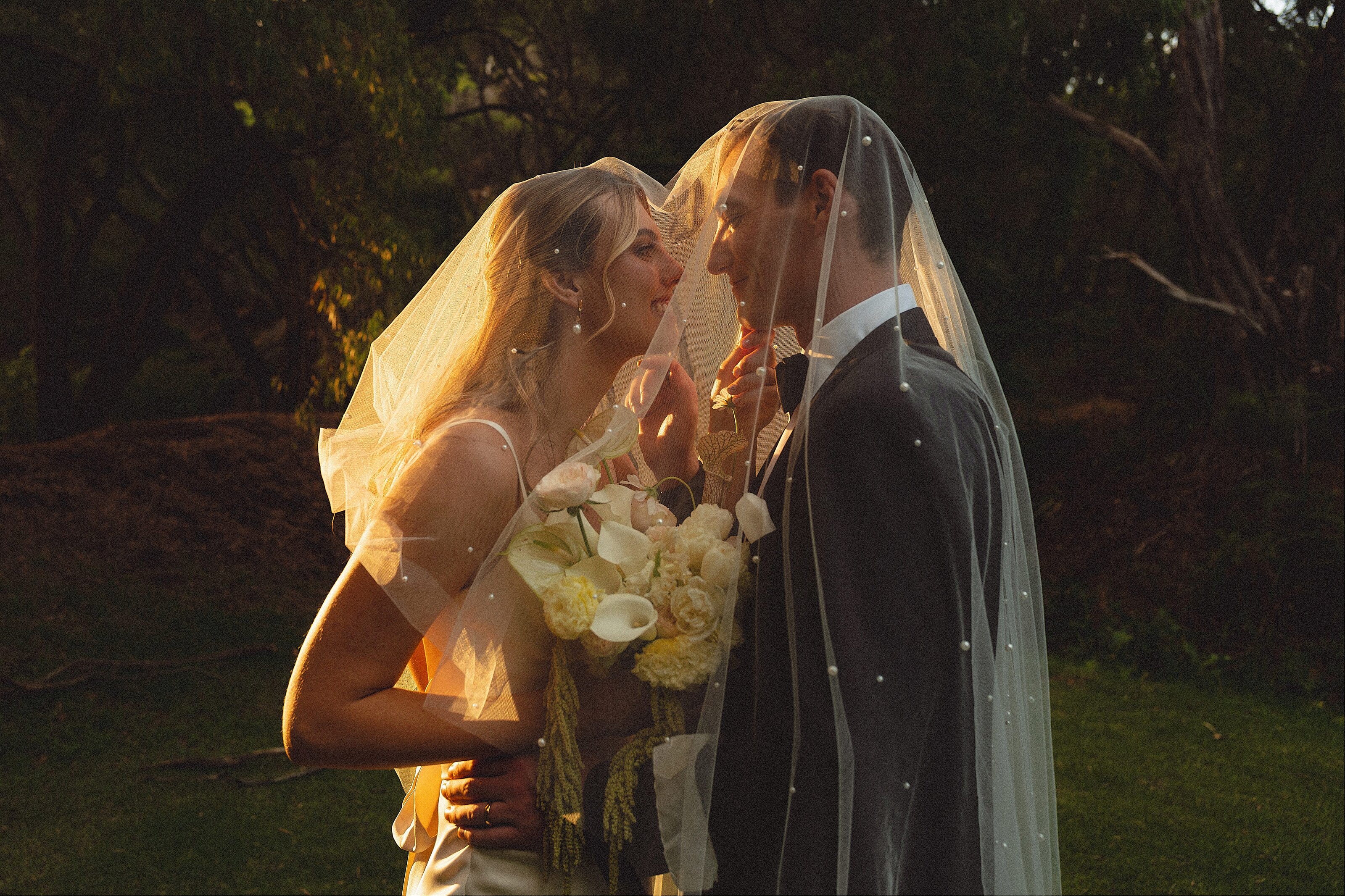 Romantic sunset wedding portraits in the heritage gardens at Caves House Hotel in Yallingup