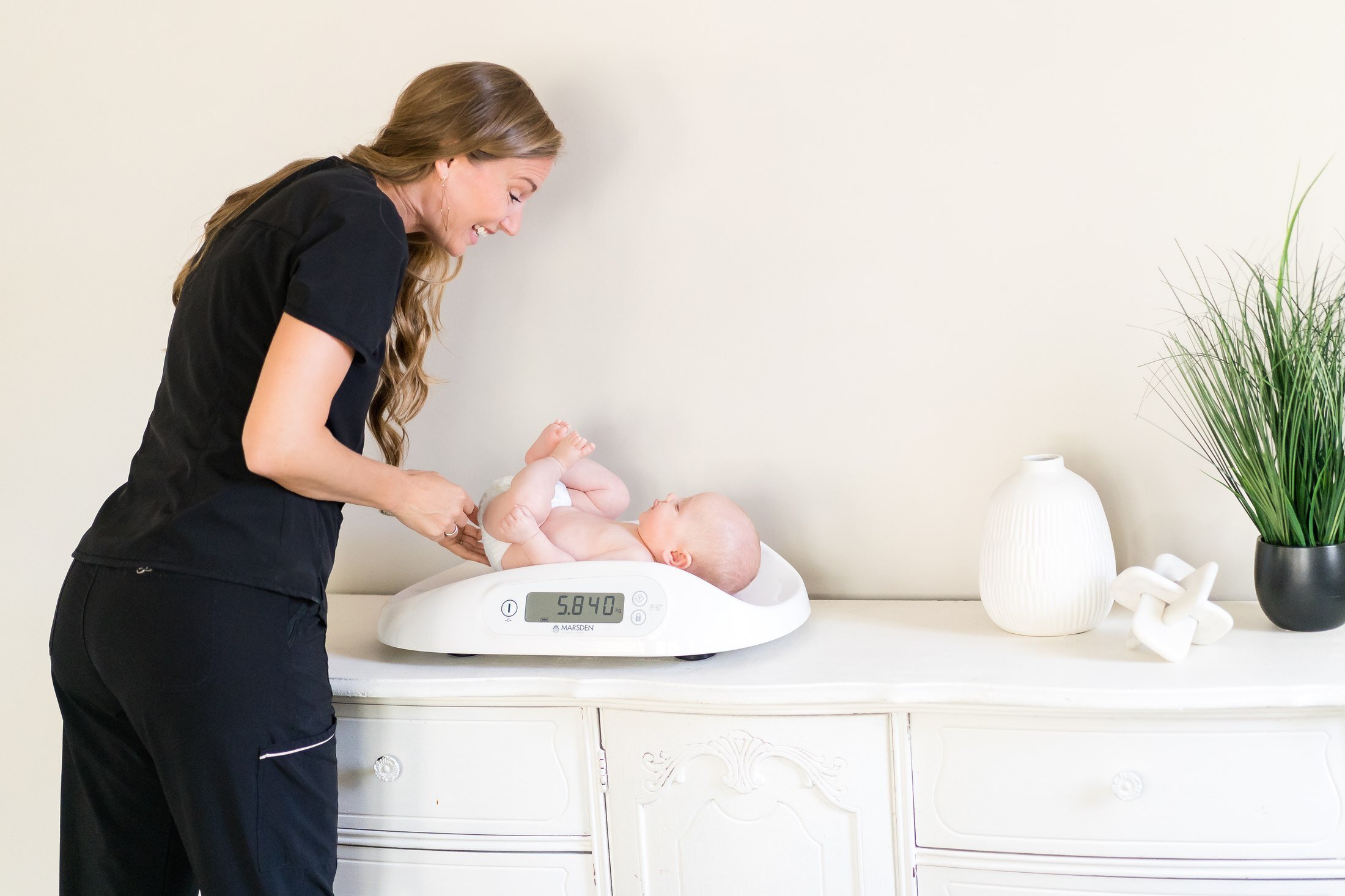 Postpartum newborn weight check for Stork Maternity Consulting