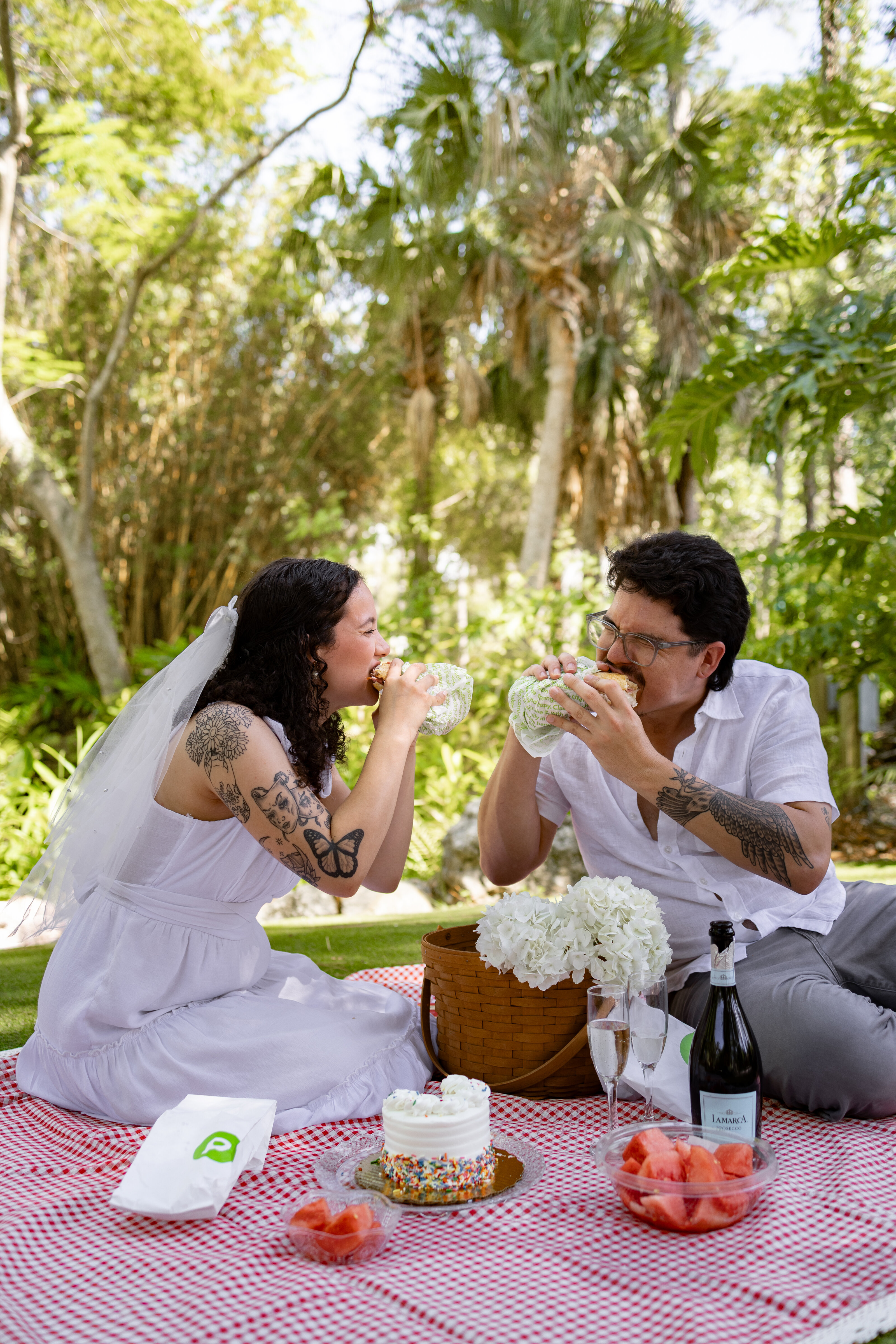 Couple enjoying Publix subs during a picnic elopement