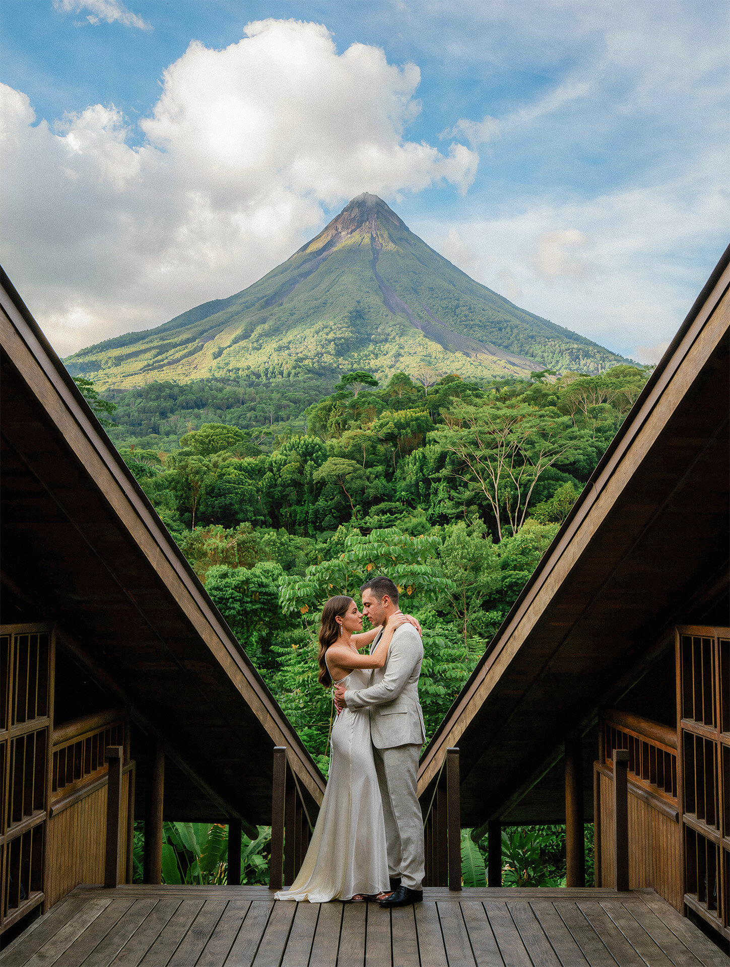 Bride and groom embracing near Arenal Volcano during a Costa Rica destination wedding