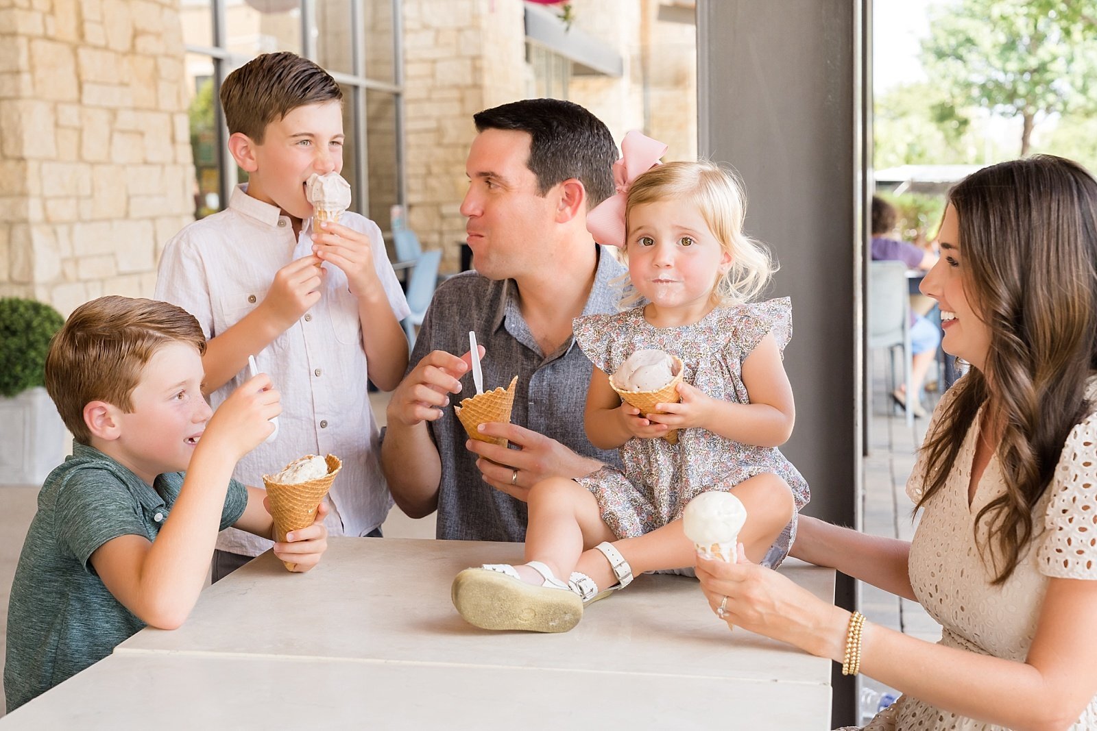 Family sharing ice cream cones at Hill Country Galleria, Austin