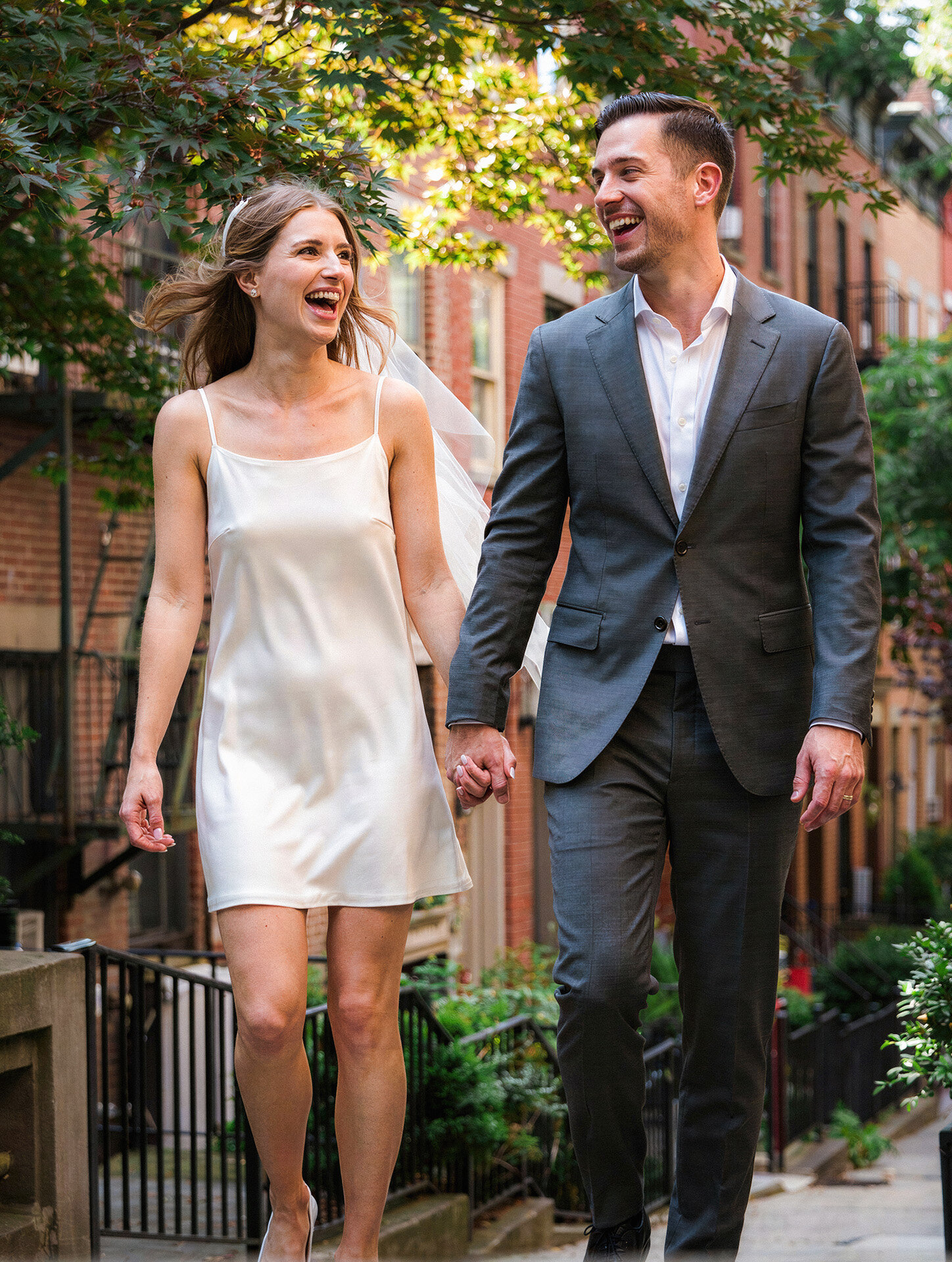 Bride and groom laughing during wedding portraits in Greenwich Village New York City
